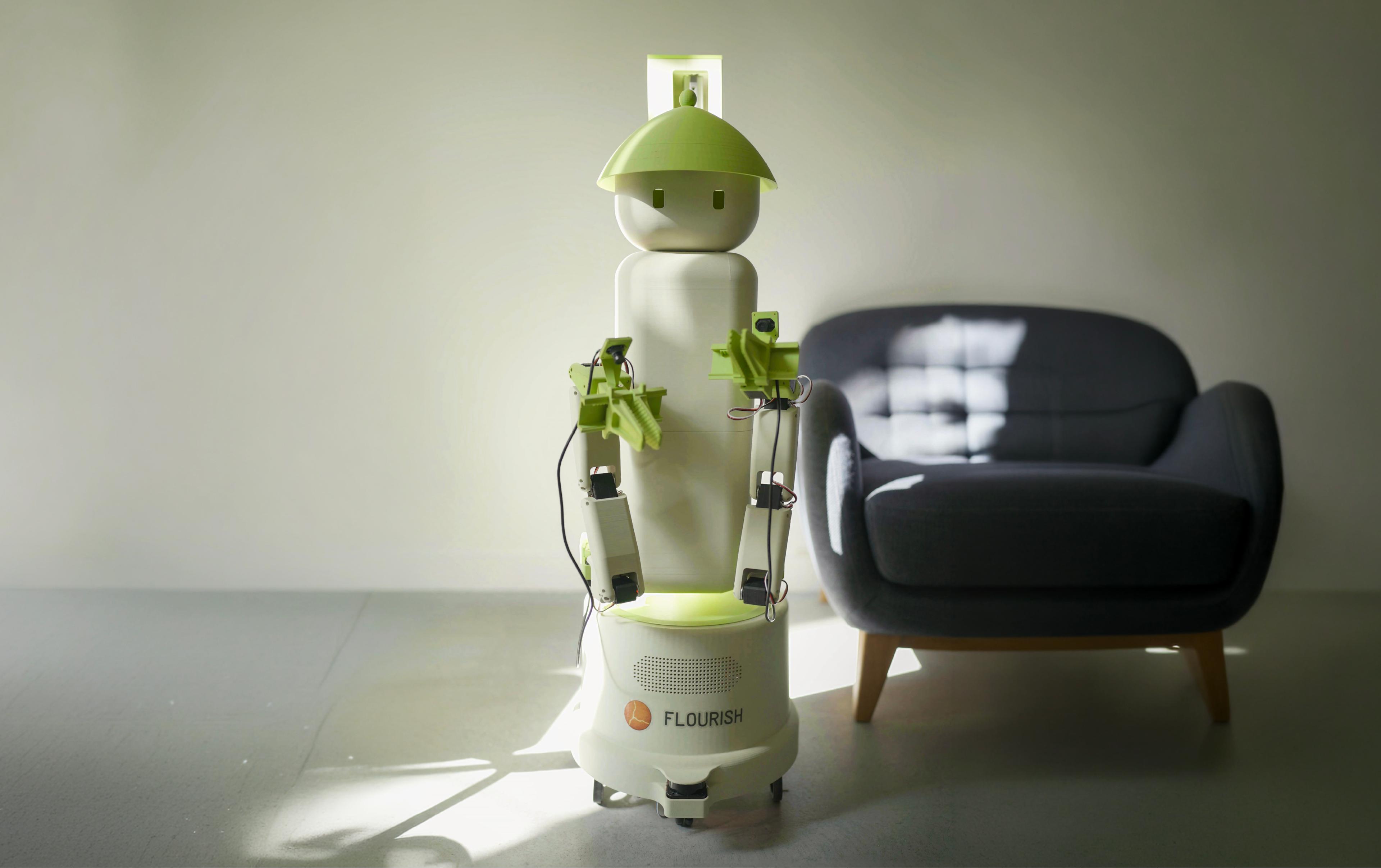 Flourish home robot standing in a living room with its dual arms and grippers visible.