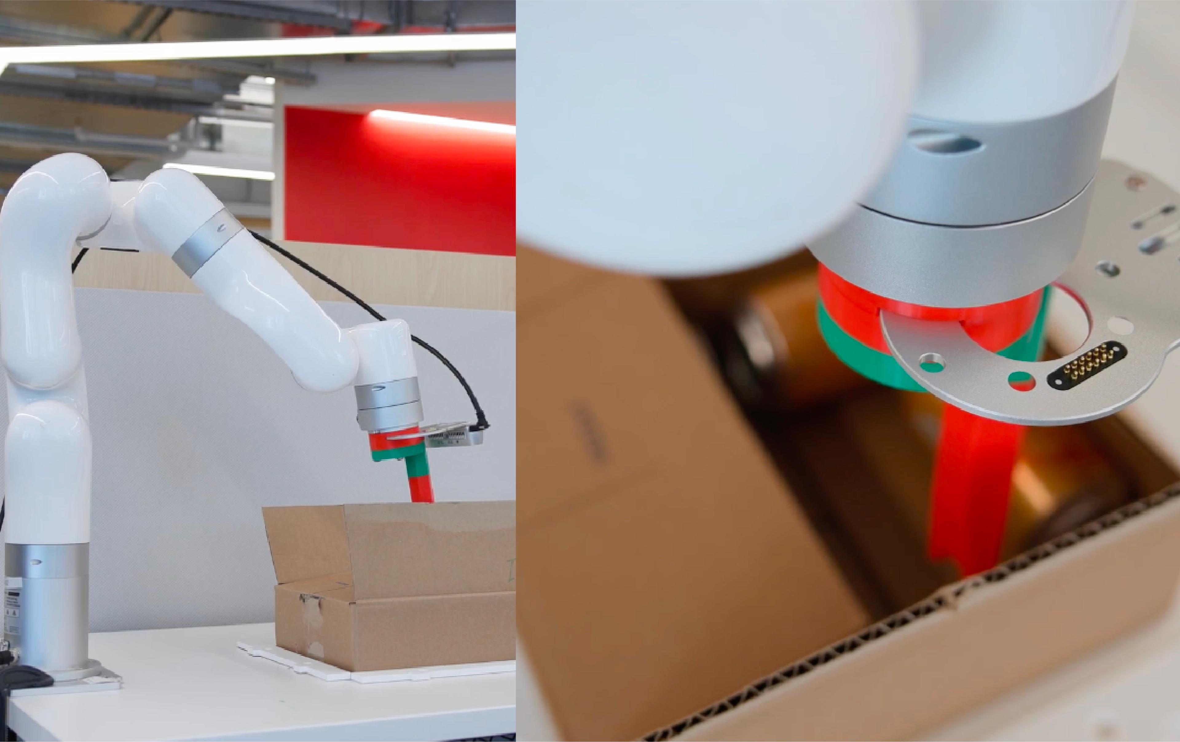 A robotic arm holds a box and a green object, showcasing its precision and versatility in handling various items.