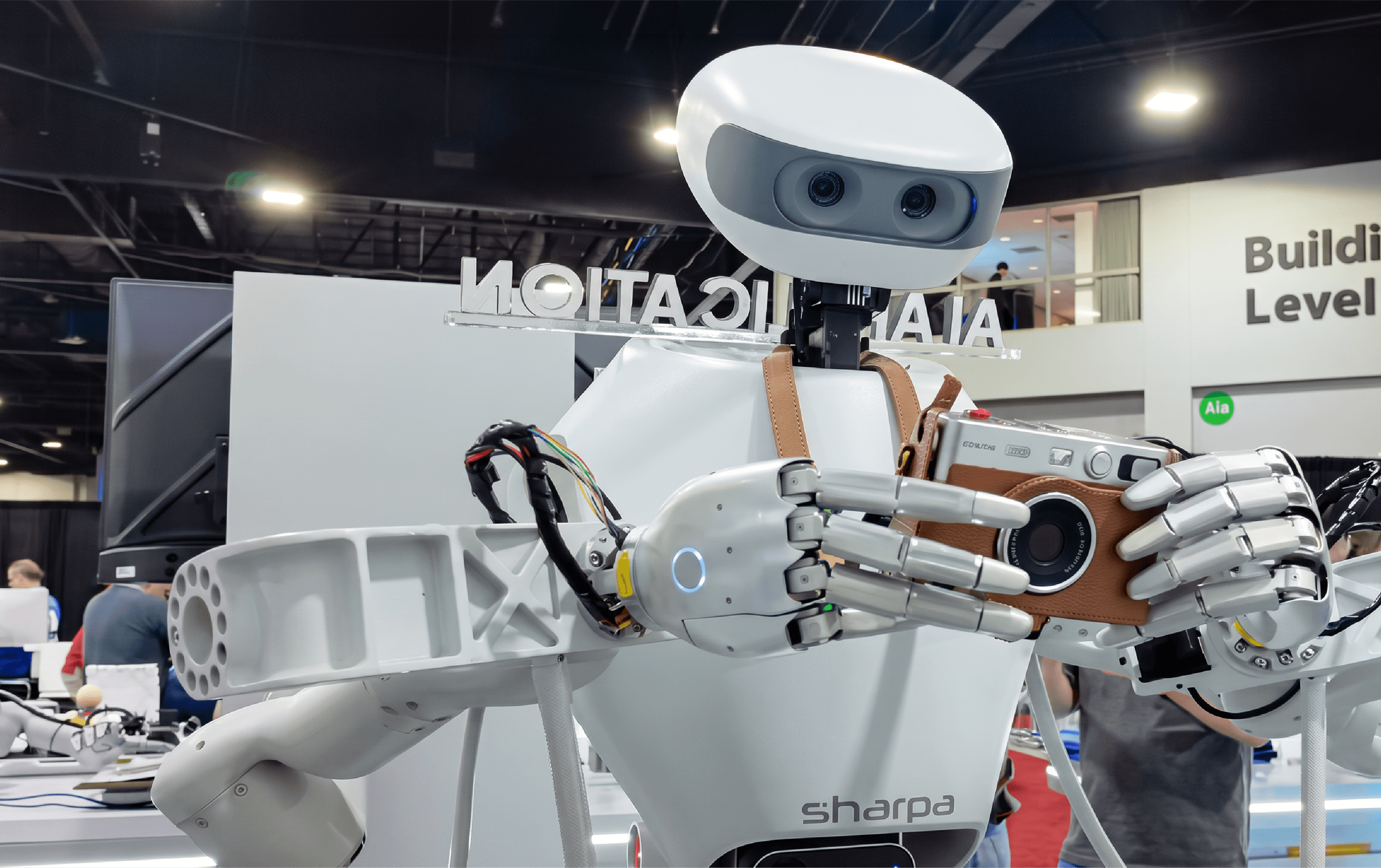 Sharpa D01 robot uses dexterous hands to hold a camera during a demonstration at IROS 2026 in Pittsburgh.