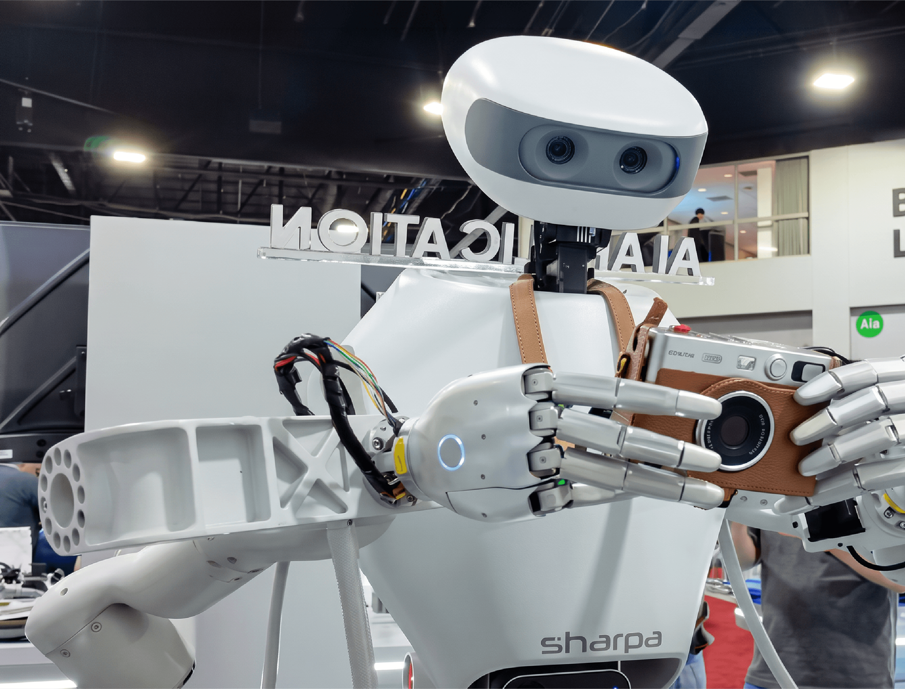 Sharpa D01 robot uses dexterous hands to hold a camera during a demonstration at IROS 2026 in Pittsburgh.