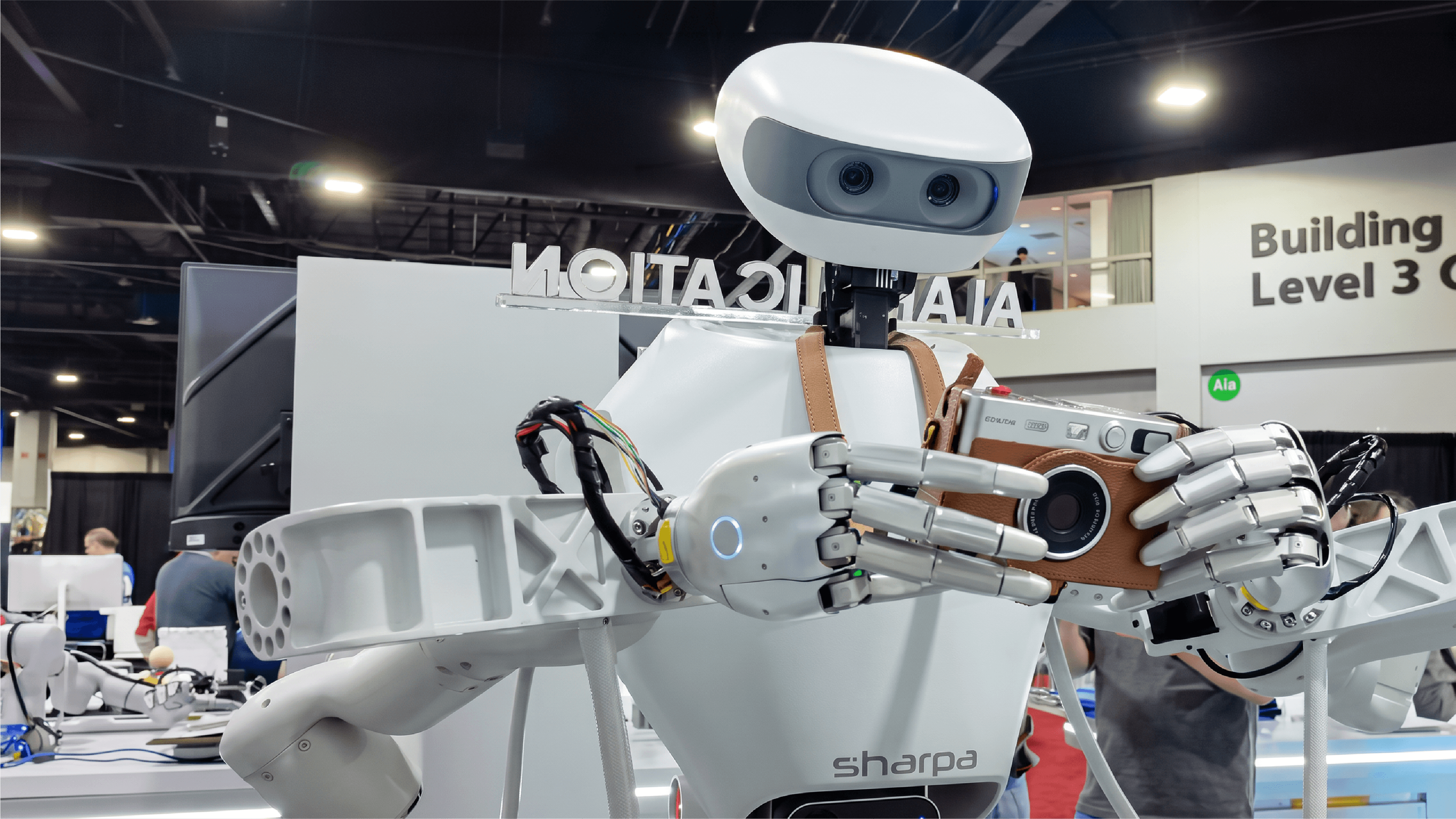 Sharpa D01 robot uses dexterous hands to hold a camera during a demonstration at IROS 2026 in Pittsburgh.