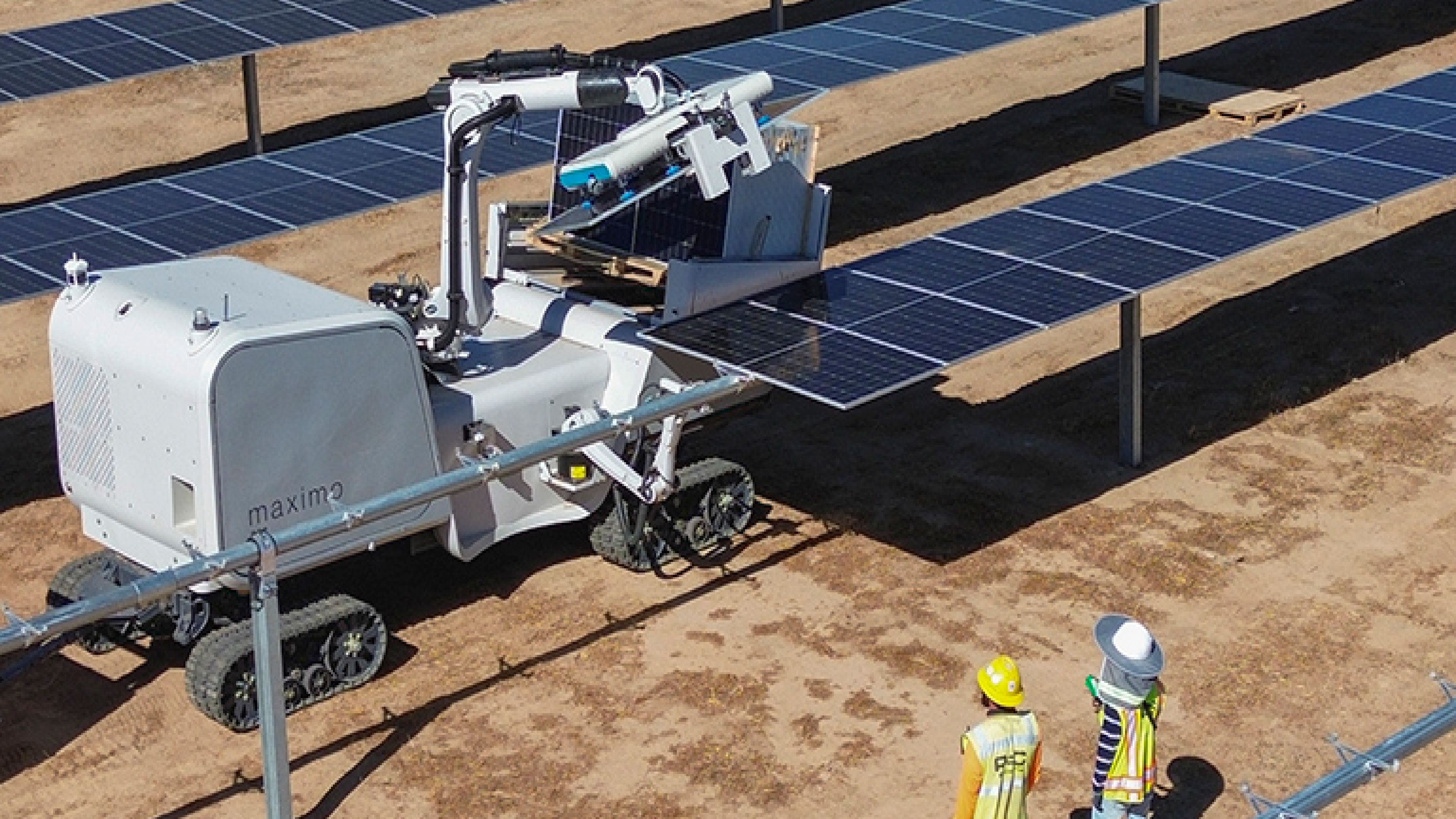 Maximo Robotics' tracked robot positions a solar panel on a mounting structure at a solar farm.