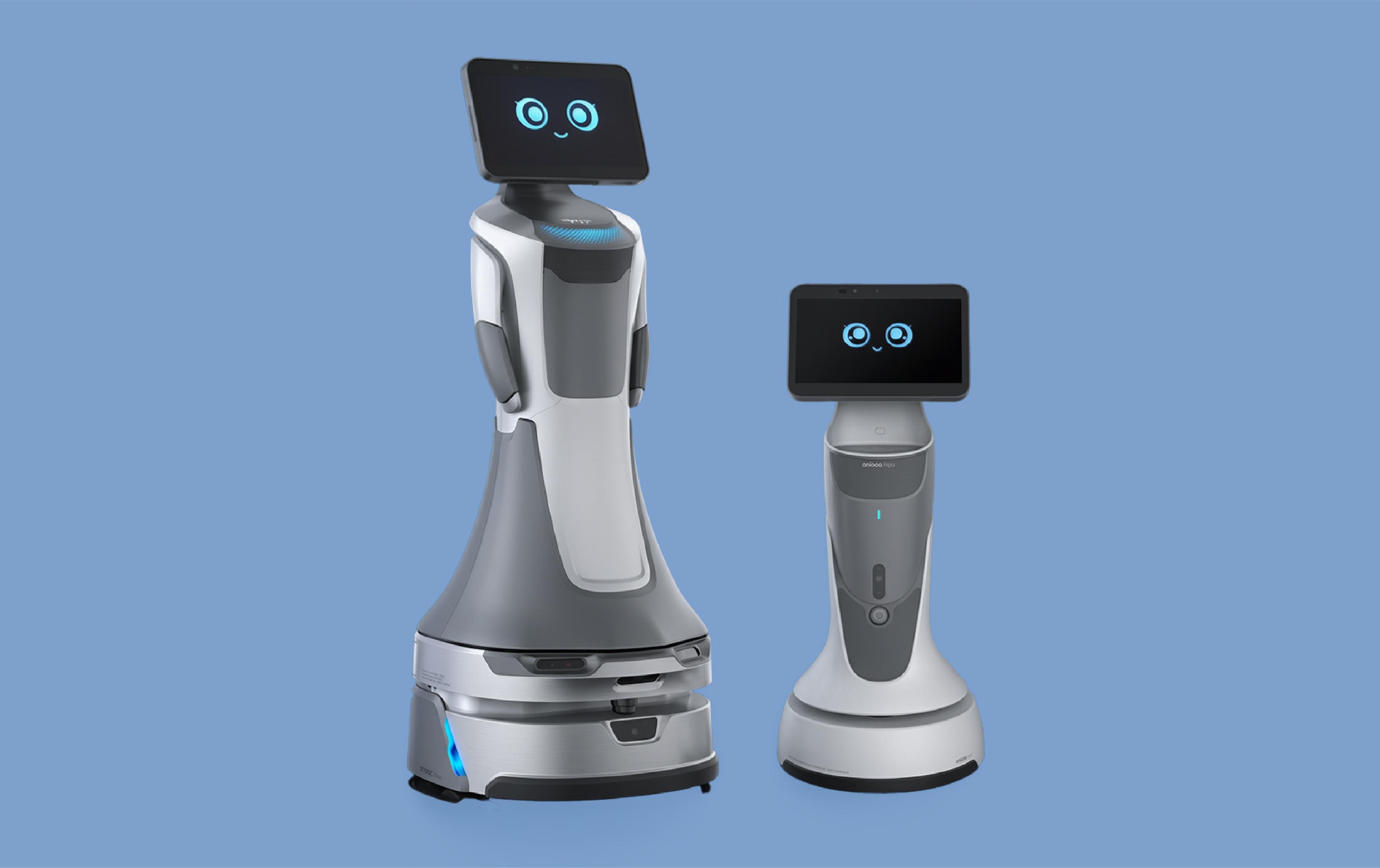 Two wheeled passenger-service robots with animated faces displayed on screens against a blue background.