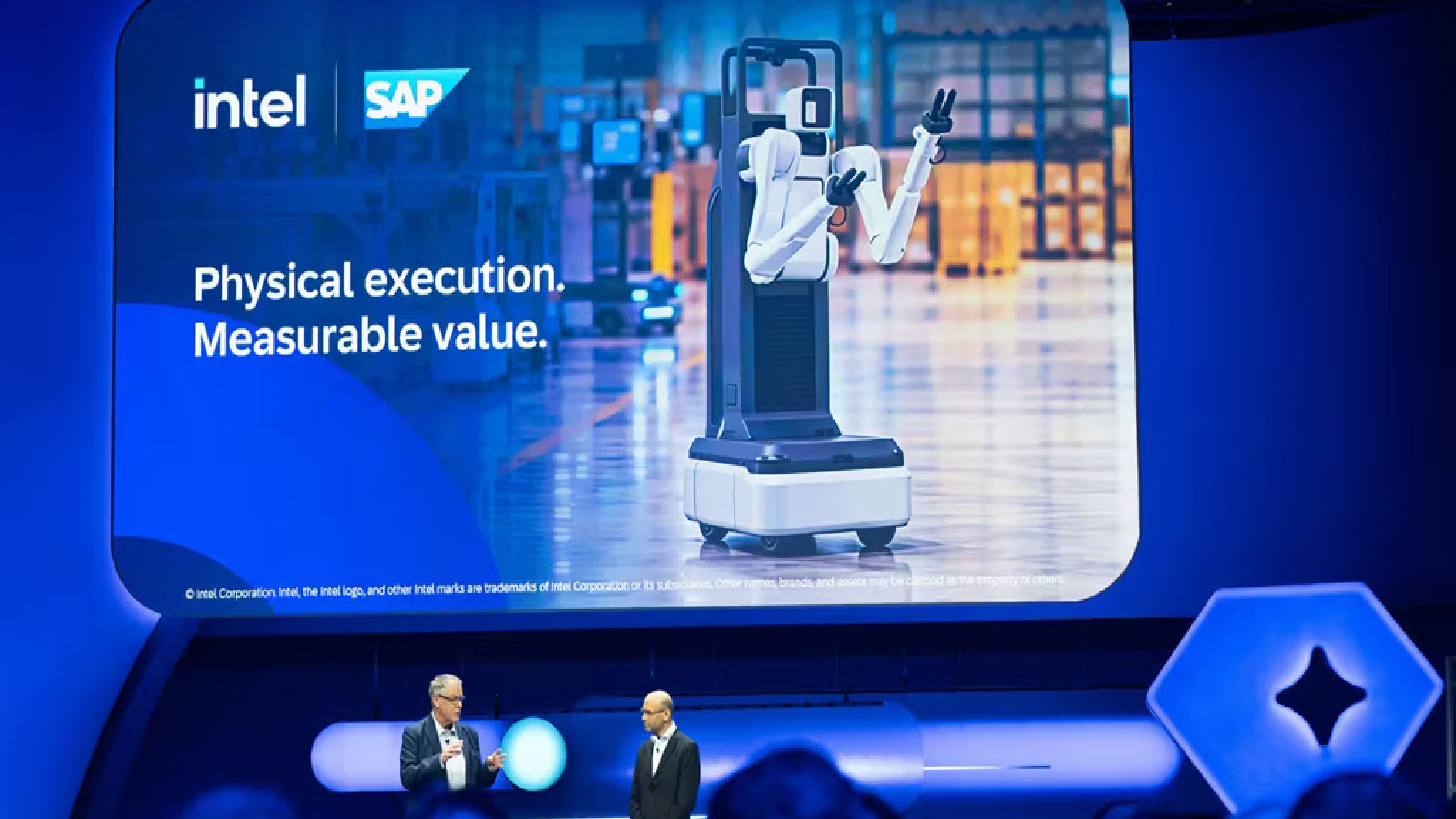 Intel and SAP present their physical AI collaboration at a technology event, with a screen showing a mobile robot.