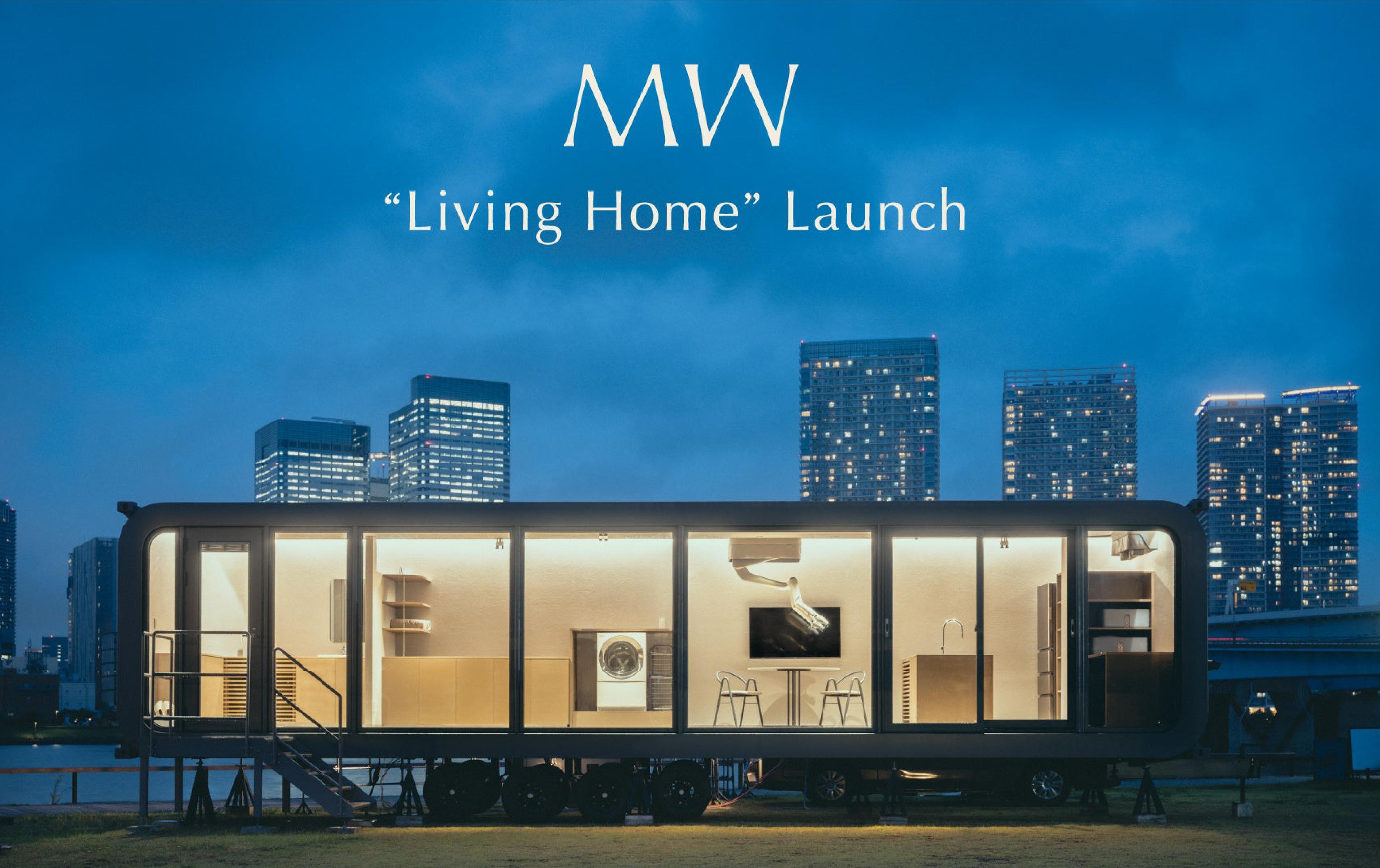 MW’s illuminated Living Home trailer prototype at night, with a ceiling-mounted robotic arm visible inside.