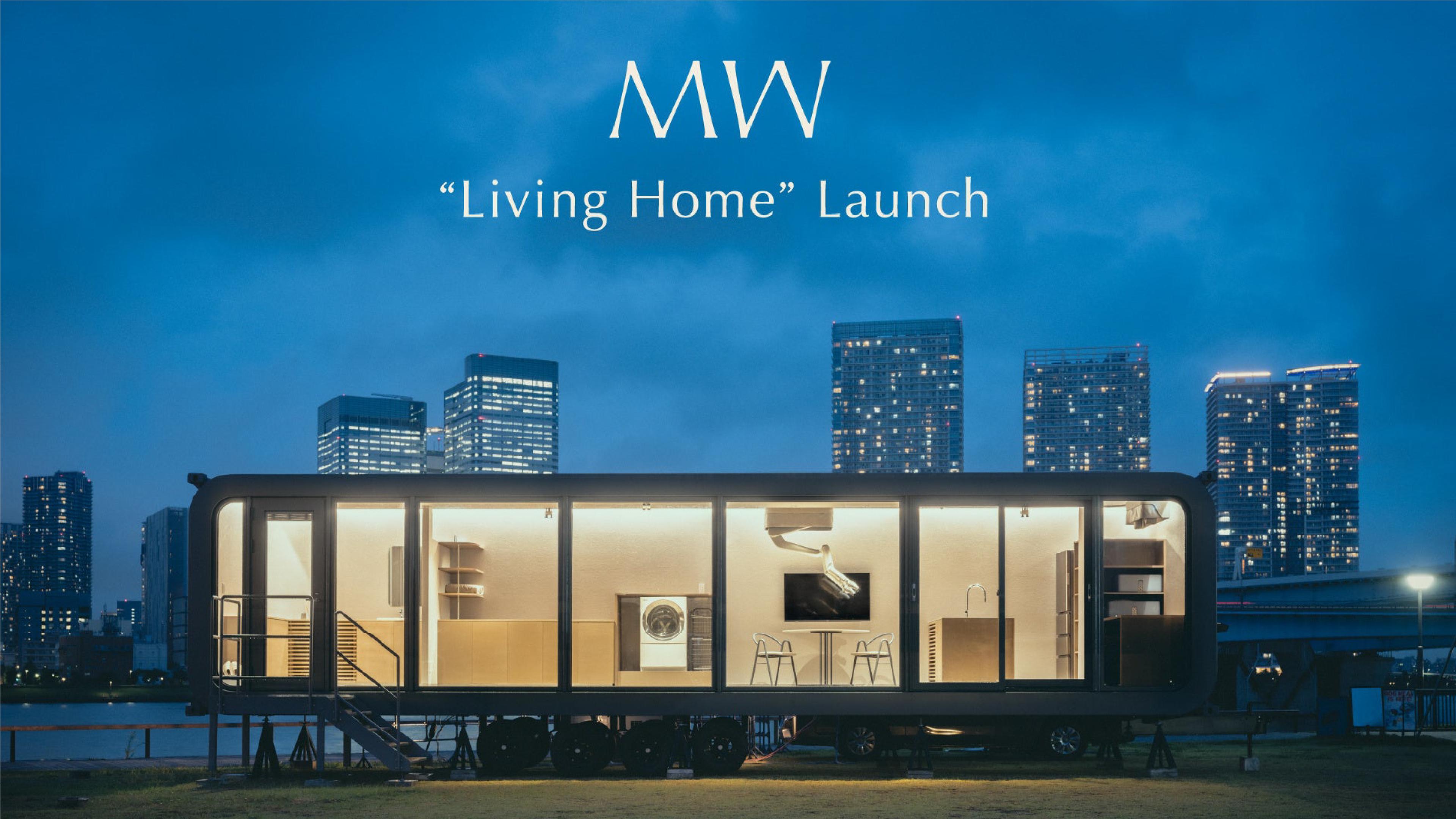 MW’s illuminated Living Home trailer prototype at night, with a ceiling-mounted robotic arm visible inside.
