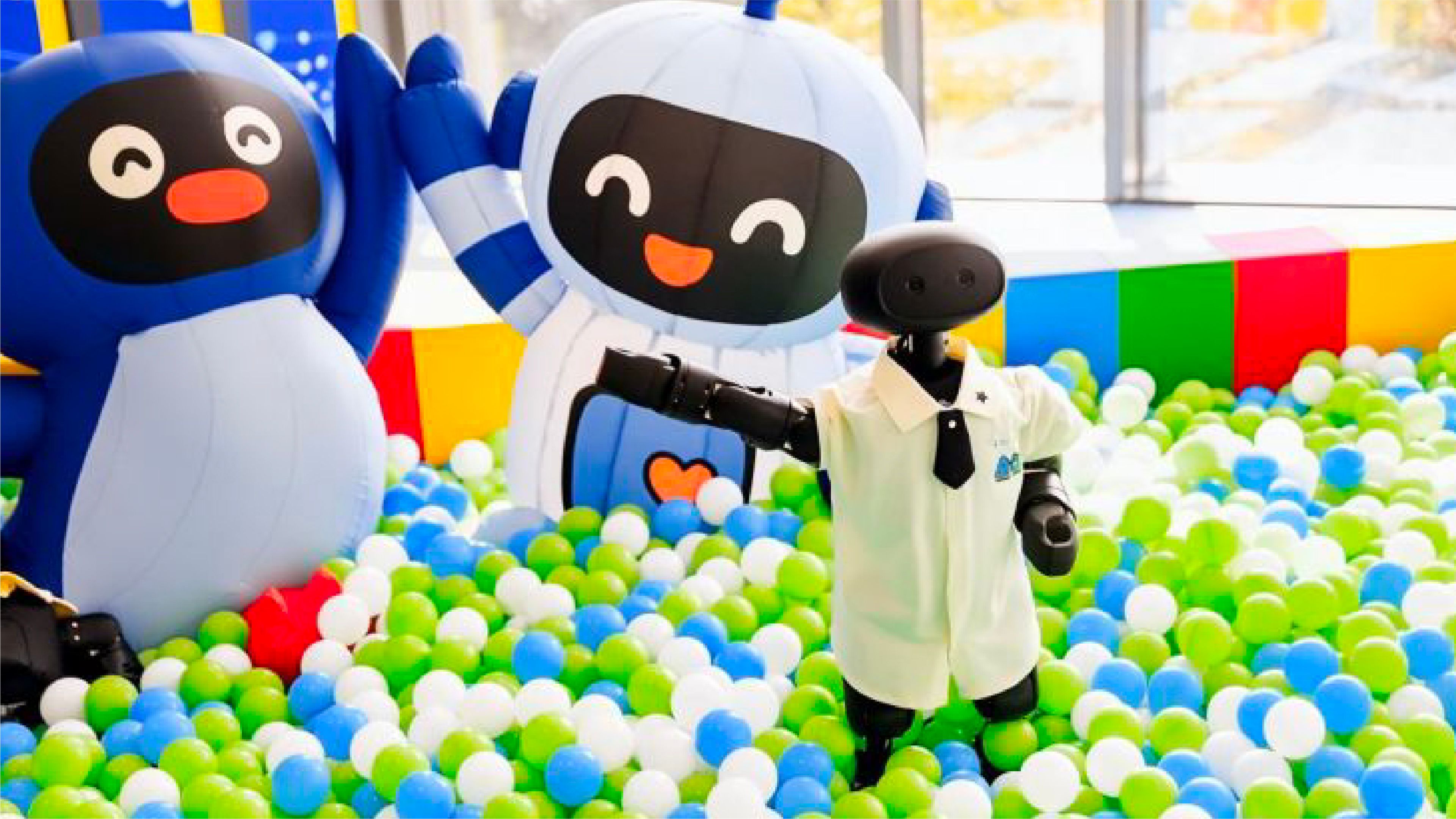 A vibrant room filled with colorful balloons and various stuffed animals scattered throughout the space.