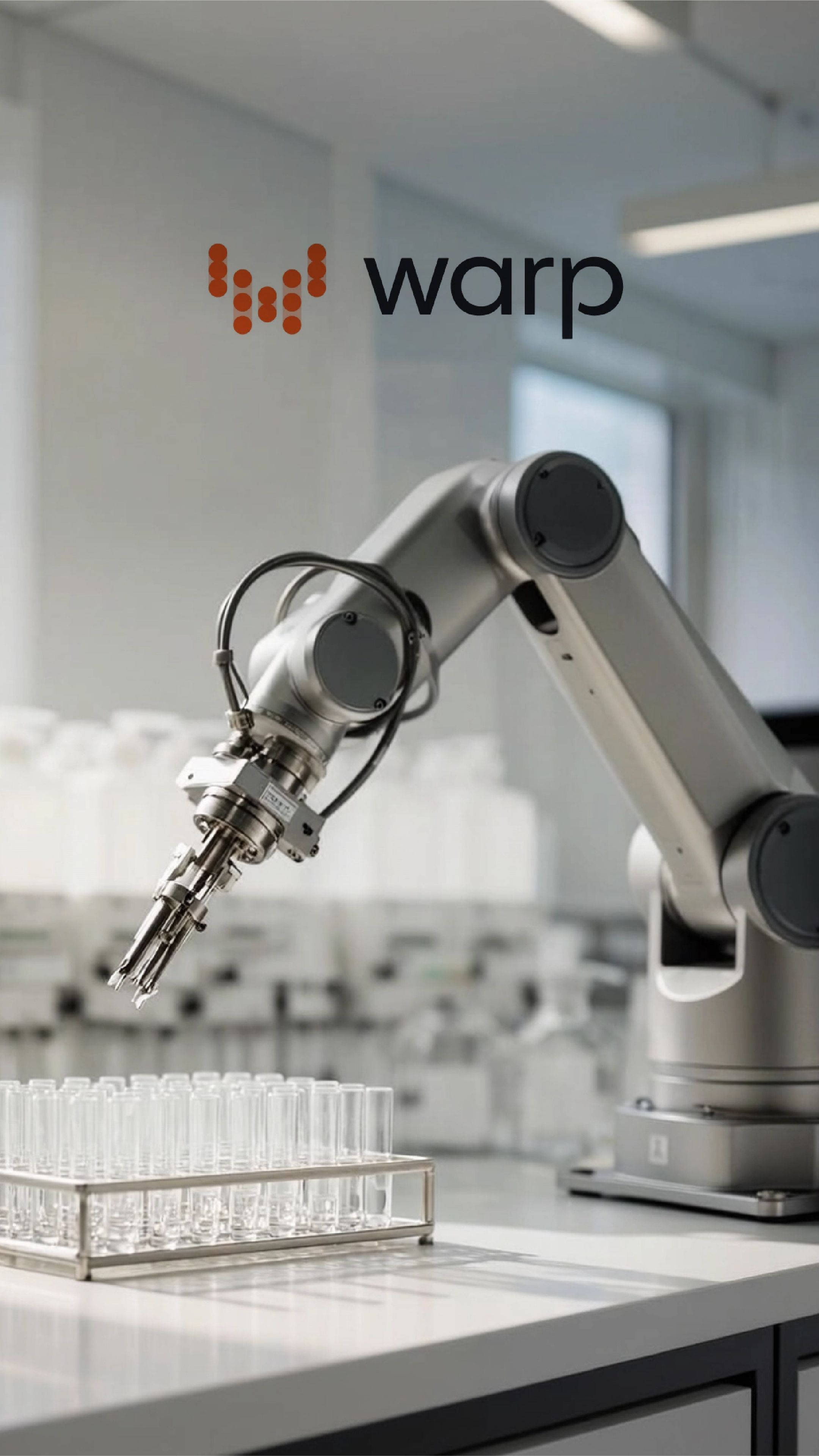 A robotic arm positioned above rows of laboratory test tubes, with the Warp Sciences logo in the upper left corner.