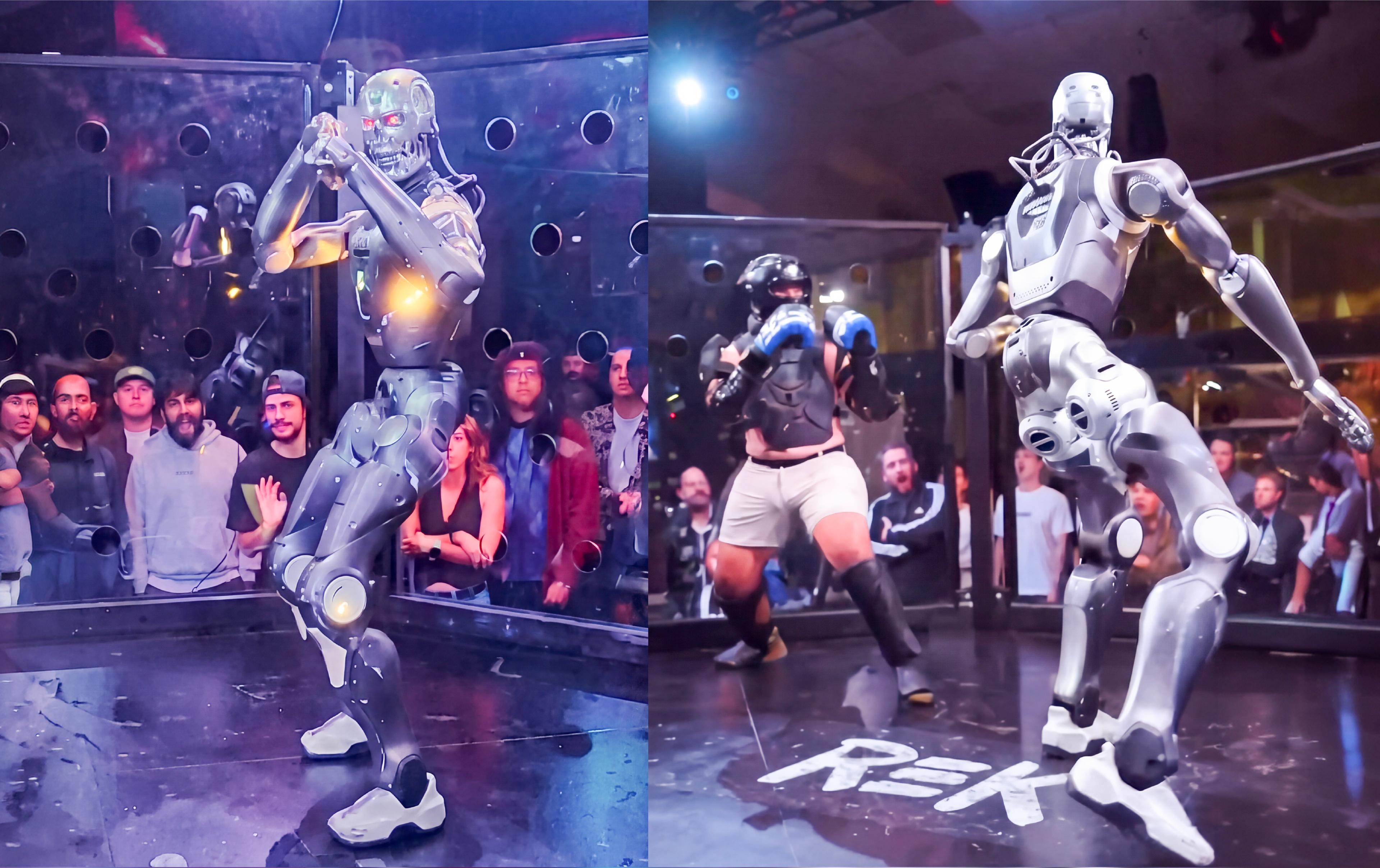 A humanoid combat robot faces a human fighter in protective gear inside a glass-walled arena, surrounded by spectators.