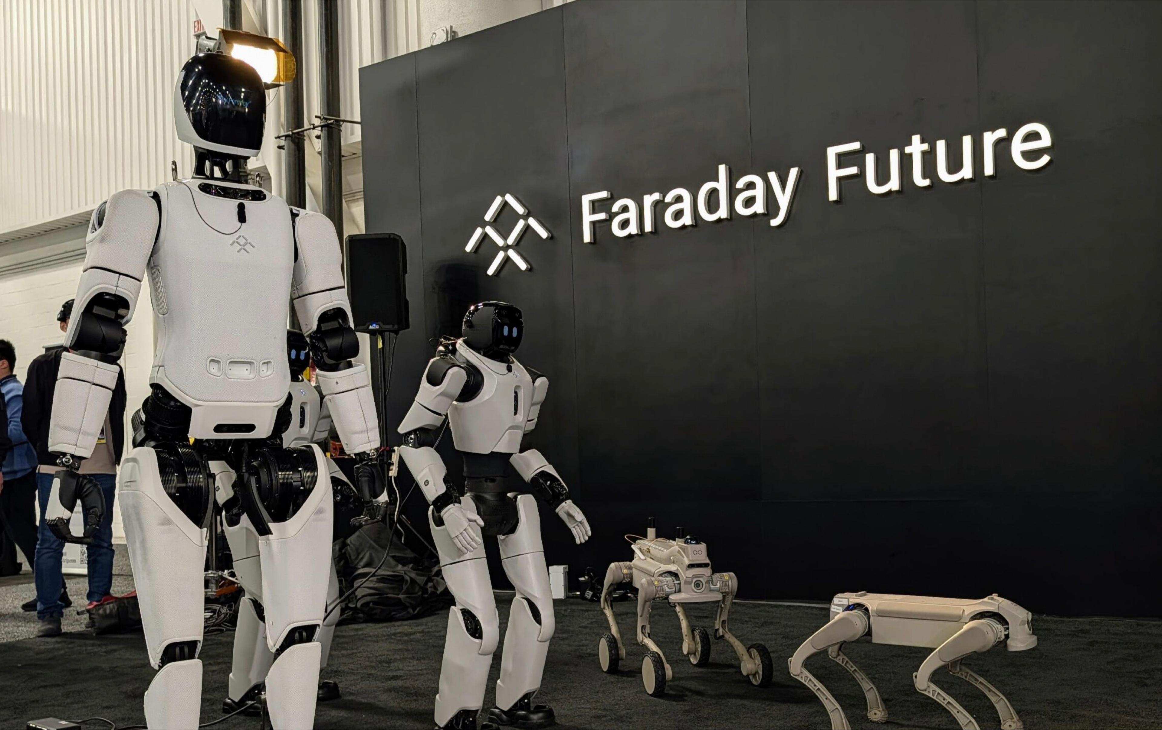 Faraday Future humanoid and quadruped robots displayed in front of the company’s logo at an exhibition.