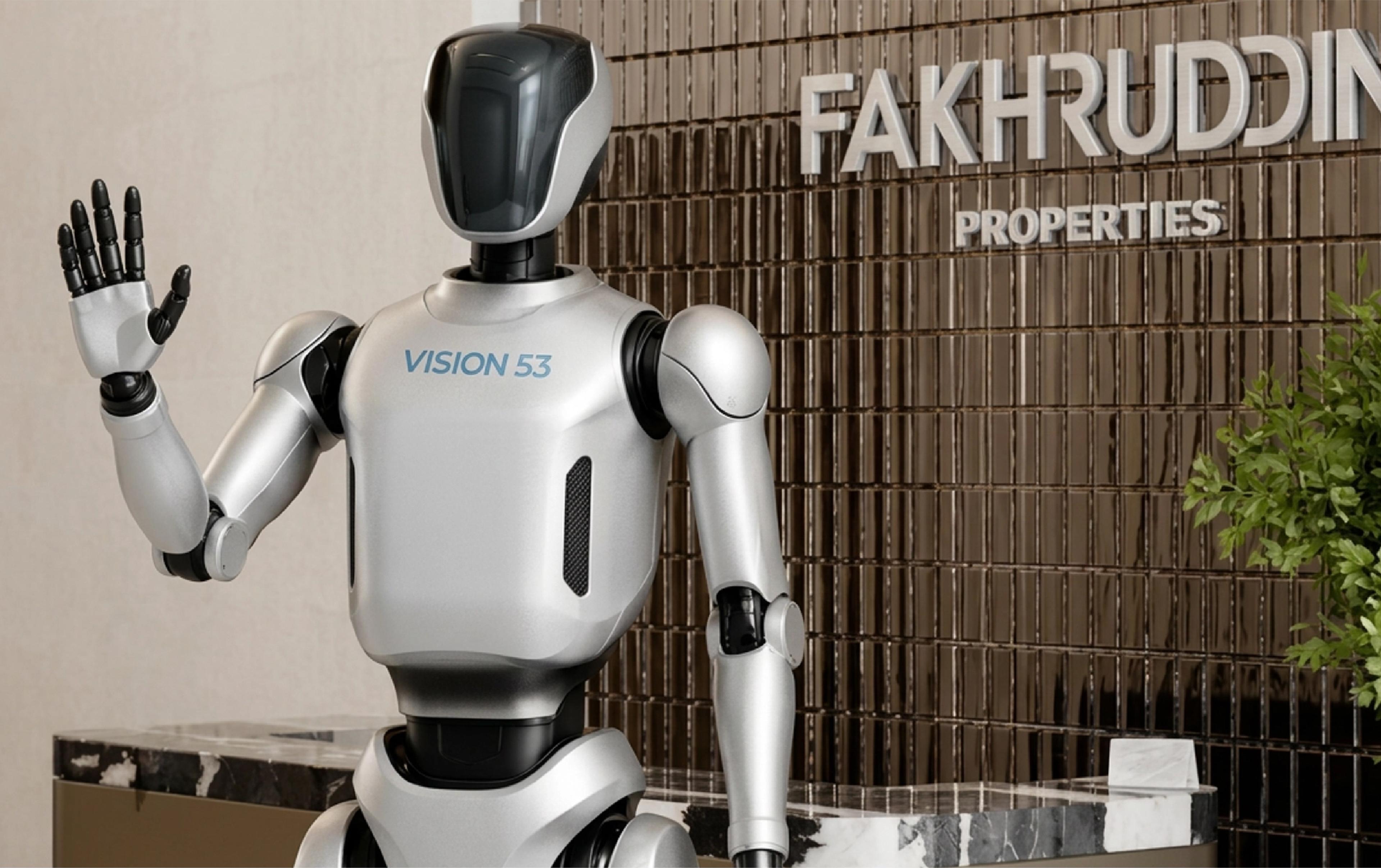 A humanoid robot labeled "VISION 53" raises one hand in a wave gesture, standing in front of a reception desk with a textured metal-tile wall reading "FAKHRUDDIN PROPERTIES" in large letters, with a green plant visible on the right.