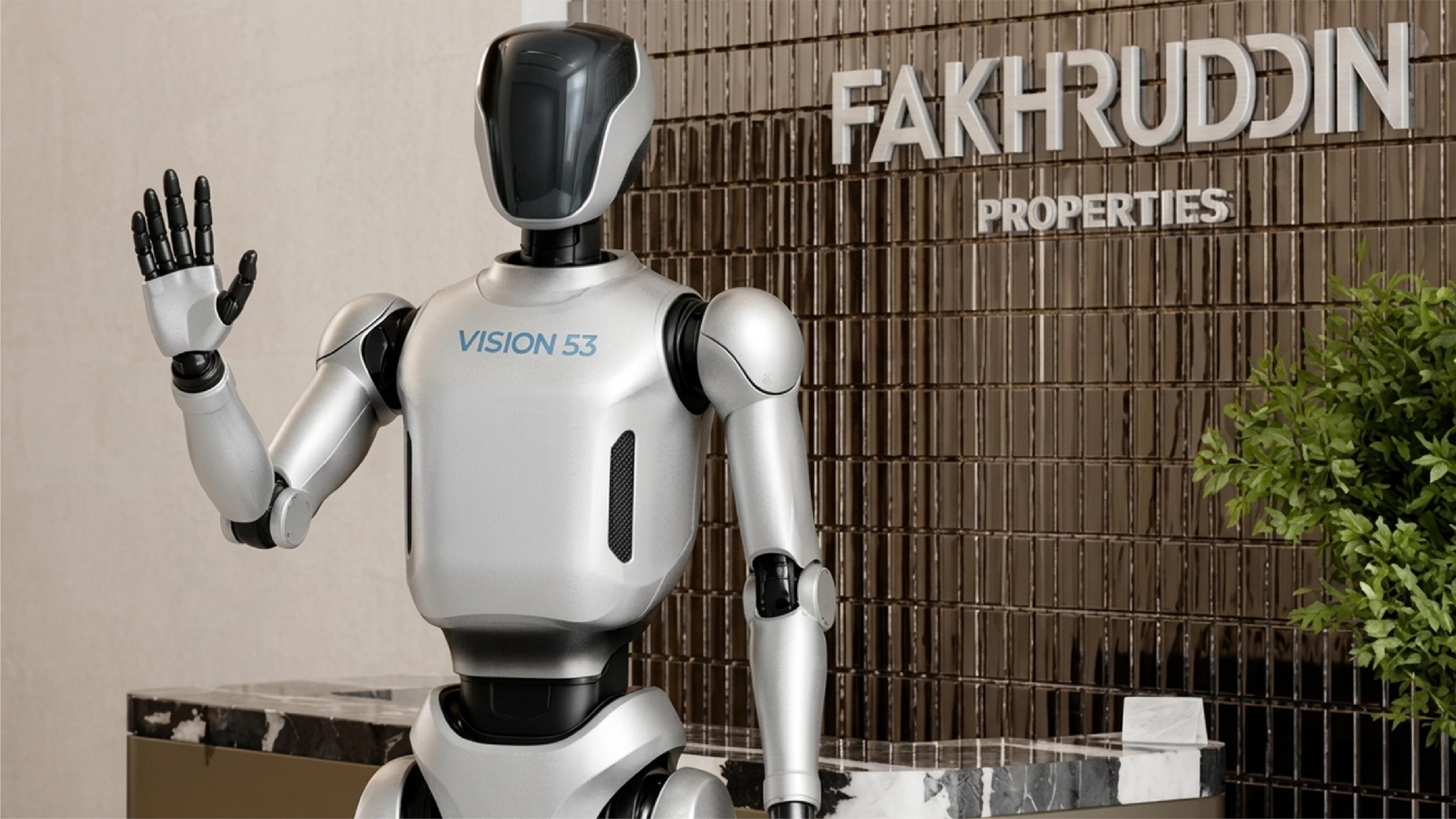 A humanoid robot labeled "VISION 53" raises one hand in a wave gesture, standing in front of a reception desk with a textured metal-tile wall reading "FAKHRUDDIN PROPERTIES" in large letters, with a green plant visible on the right.