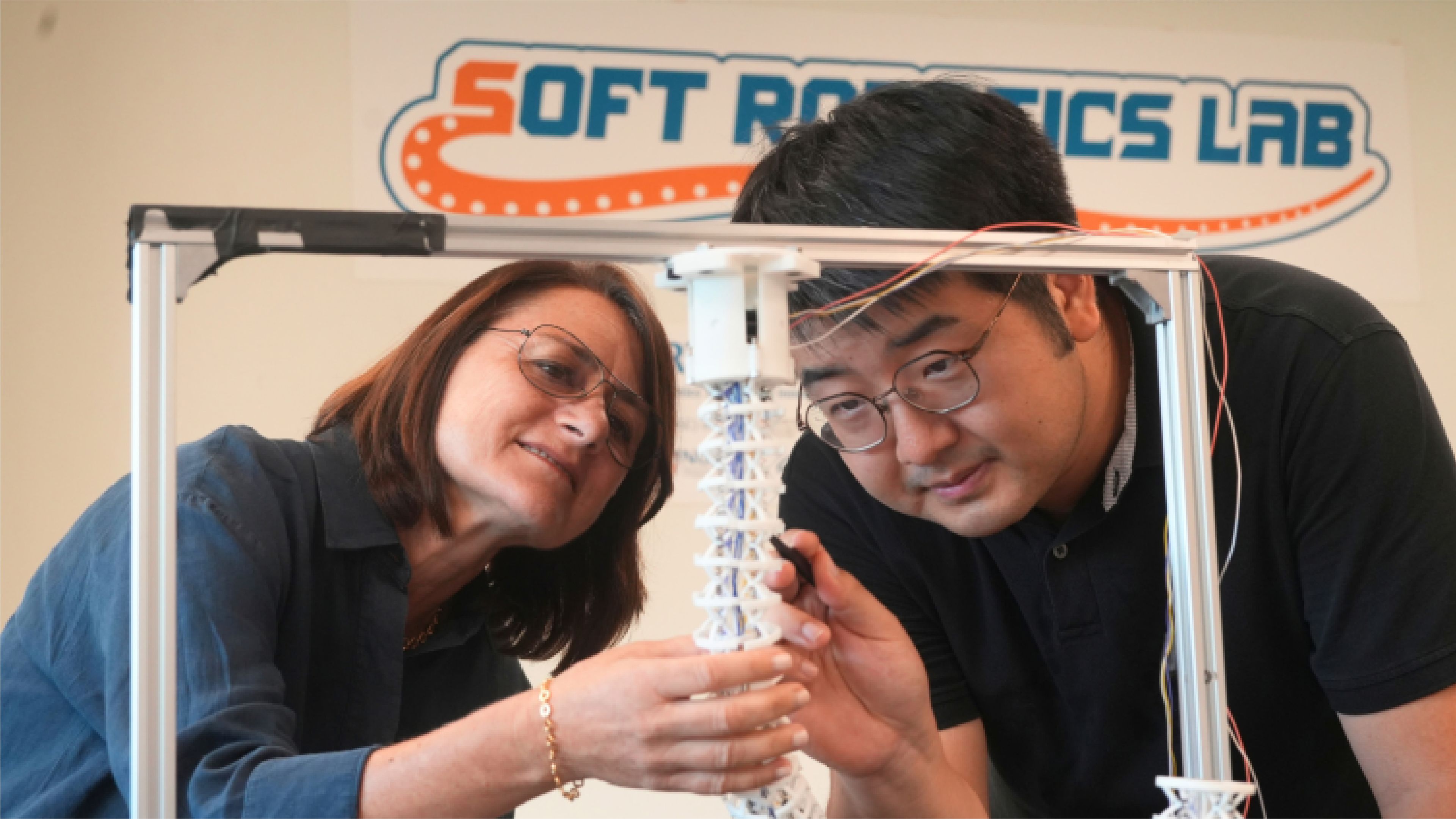 Researchers examine an octopus-inspired soft robotic arm prototype at the National University of Singapore’s Soft Robotics Lab.