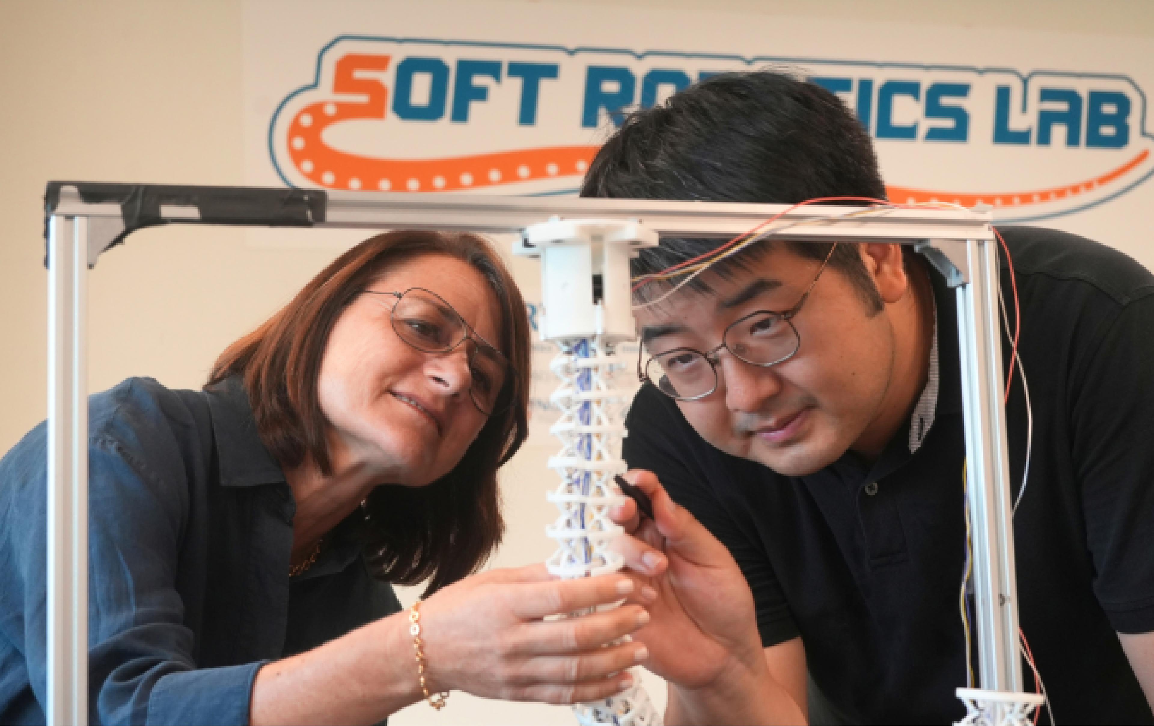 Researchers examine an octopus-inspired soft robotic arm prototype at the National University of Singapore’s Soft Robotics Lab.