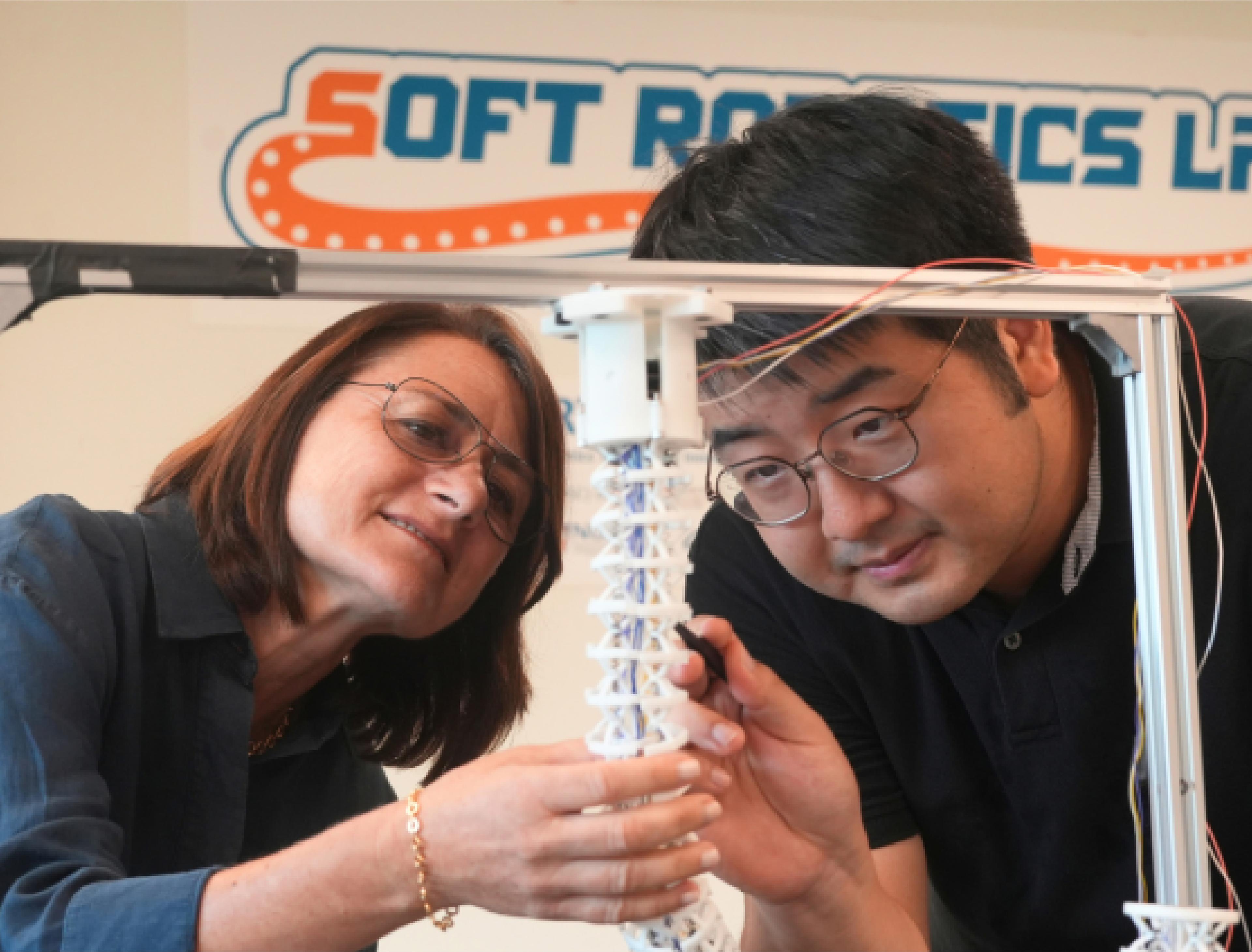 Researchers examine an octopus-inspired soft robotic arm prototype at the National University of Singapore’s Soft Robotics Lab.