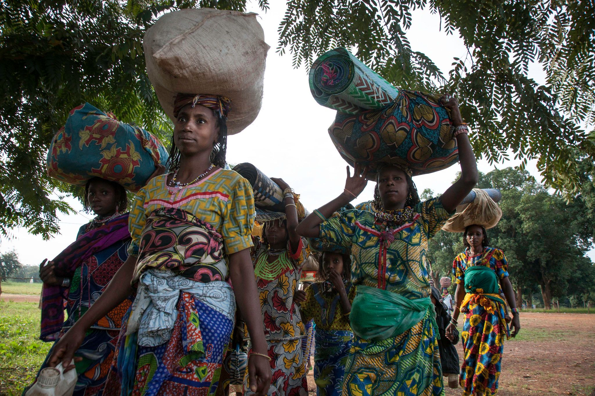 Displaced women carrying their belongings arrive in Bossangoa, Central African Republi