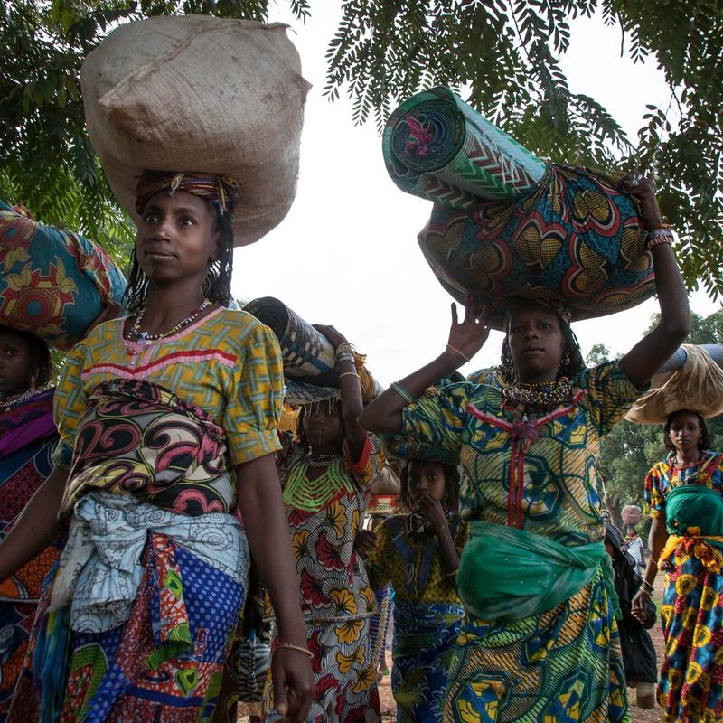 Displaced women carrying their belongings arrive in Bossangoa, Central African Republi