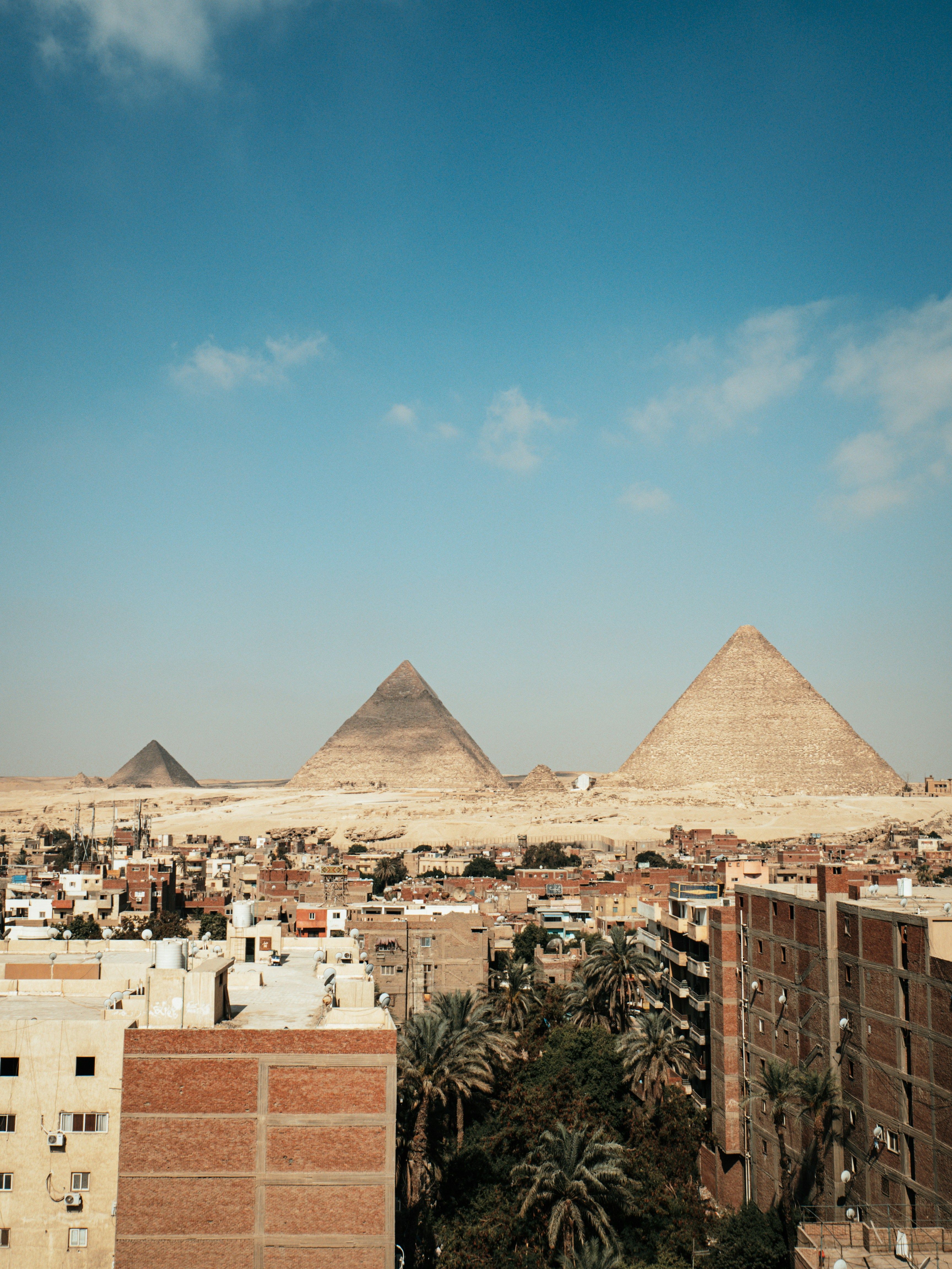 the famous pyramids in the middle of giza downtown with its houses in the morning