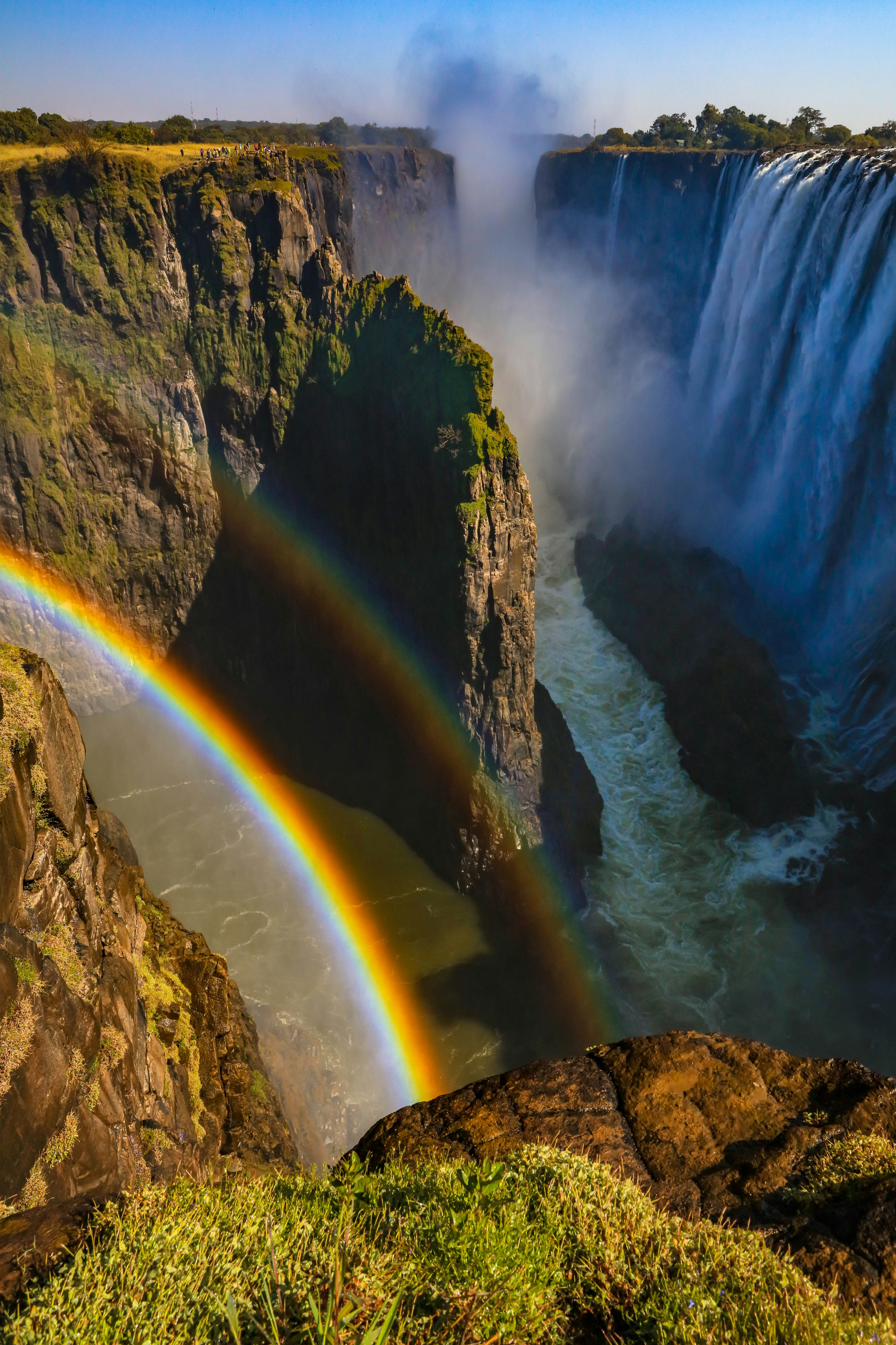 A rainbow in front of a waterfall
