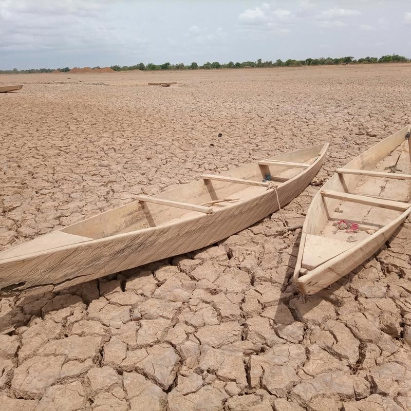 Two boats sit on very dried land