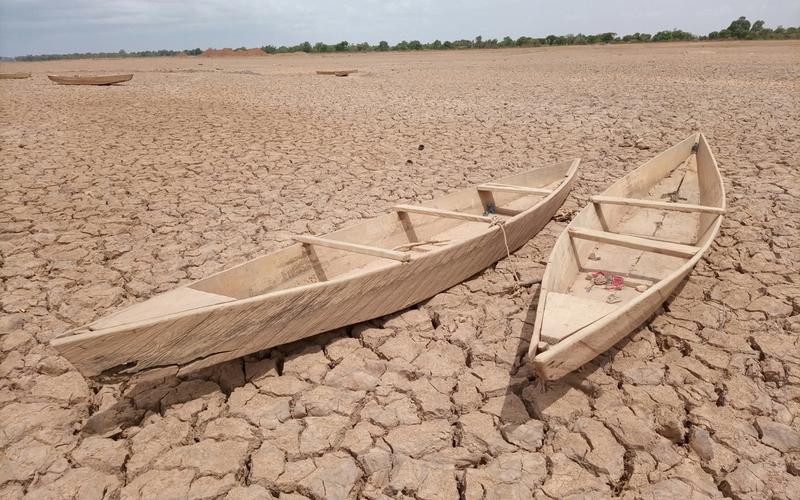 Two boats sit on very dried land
