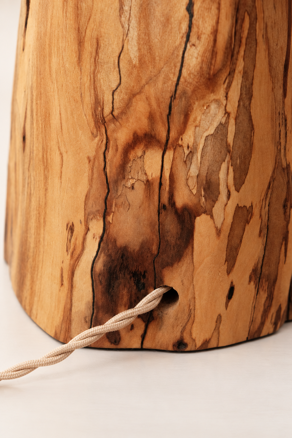 Close-up of the fabric cable on an olive wood lamp