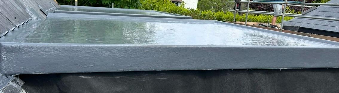 Low view across the liquid-coated flat roof and its raised perimeter