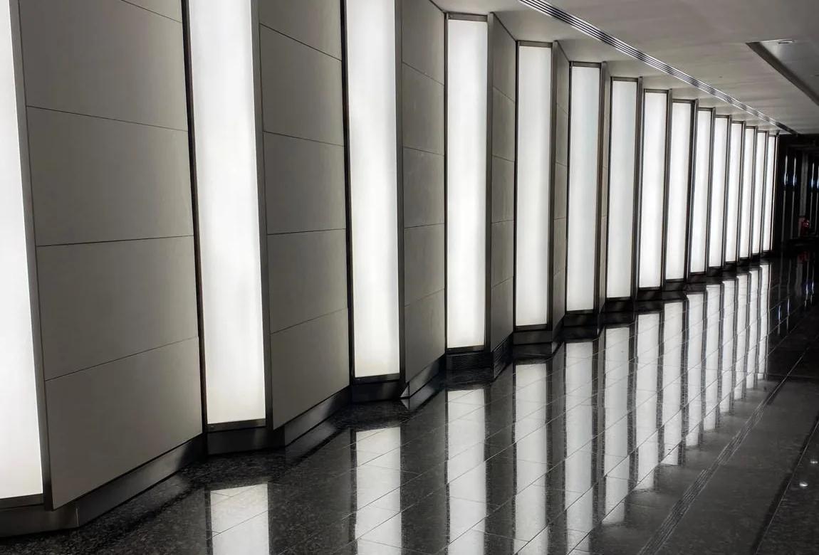 A finished commercial lobby with polished flooring and glazed entrances