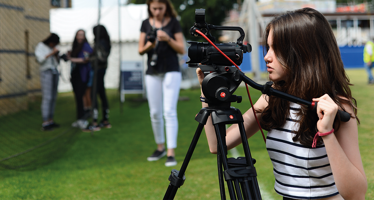 Student setting up camera for filming