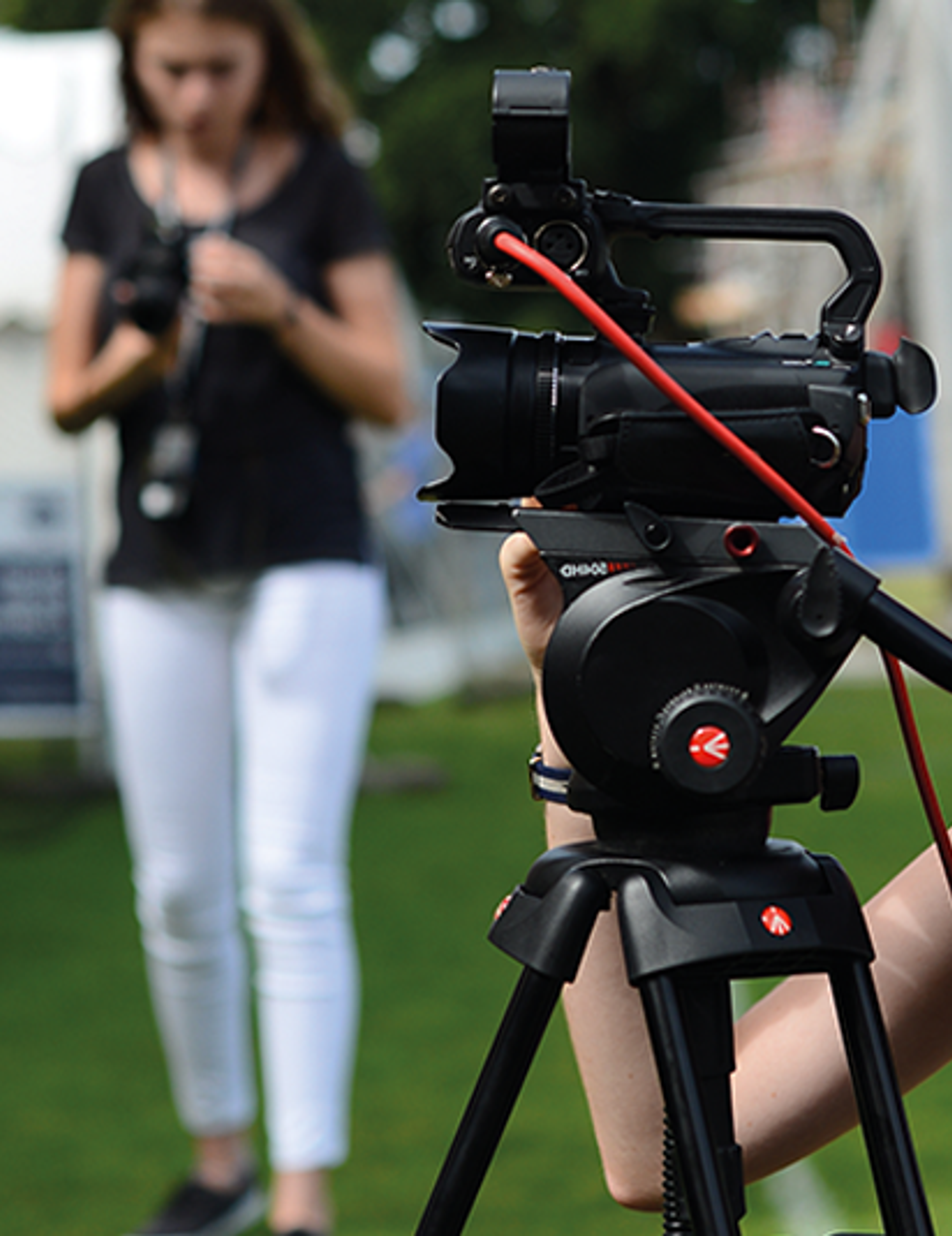 Student setting up camera for filming