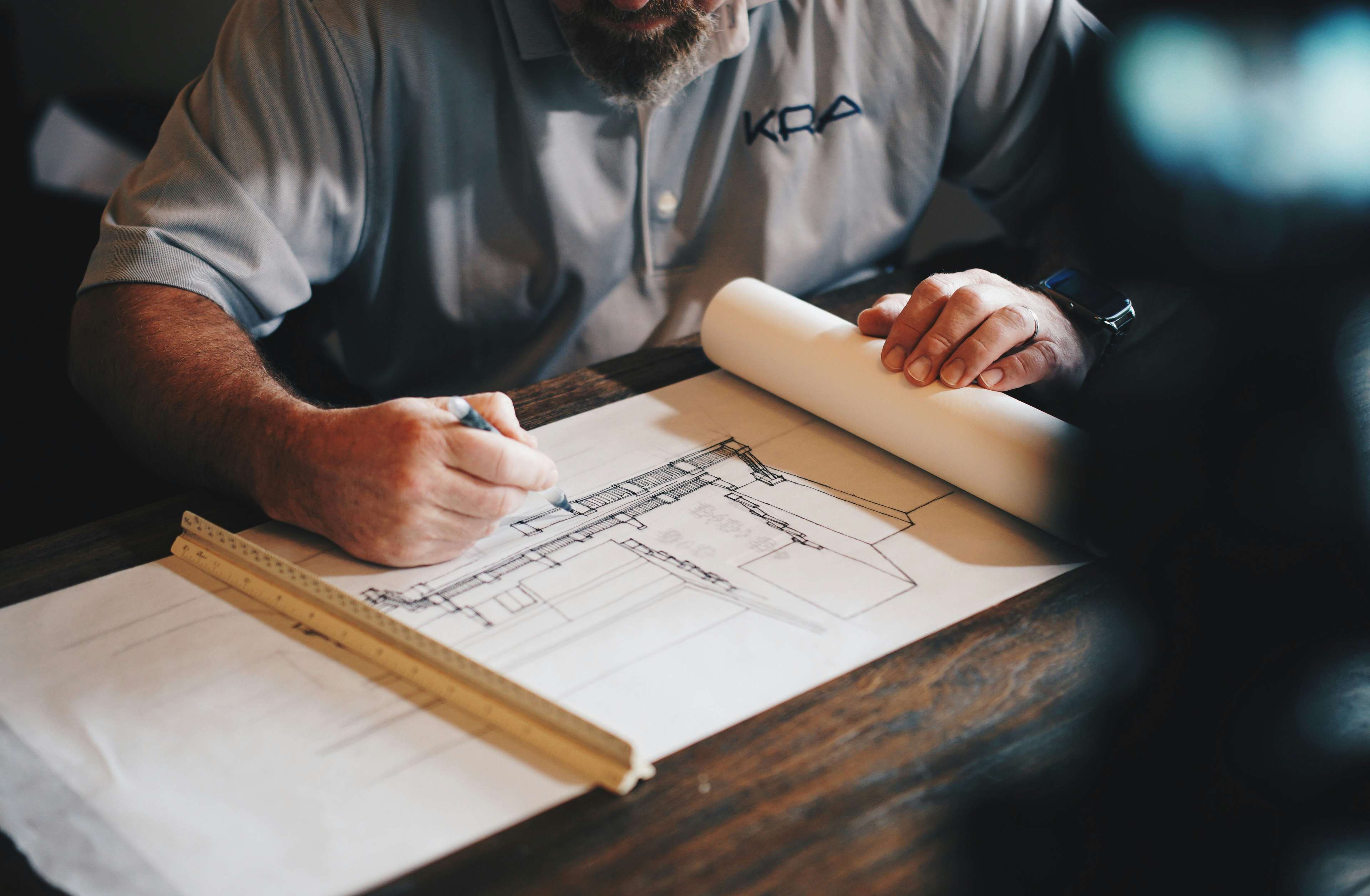 Man doing a technical drawing of a building