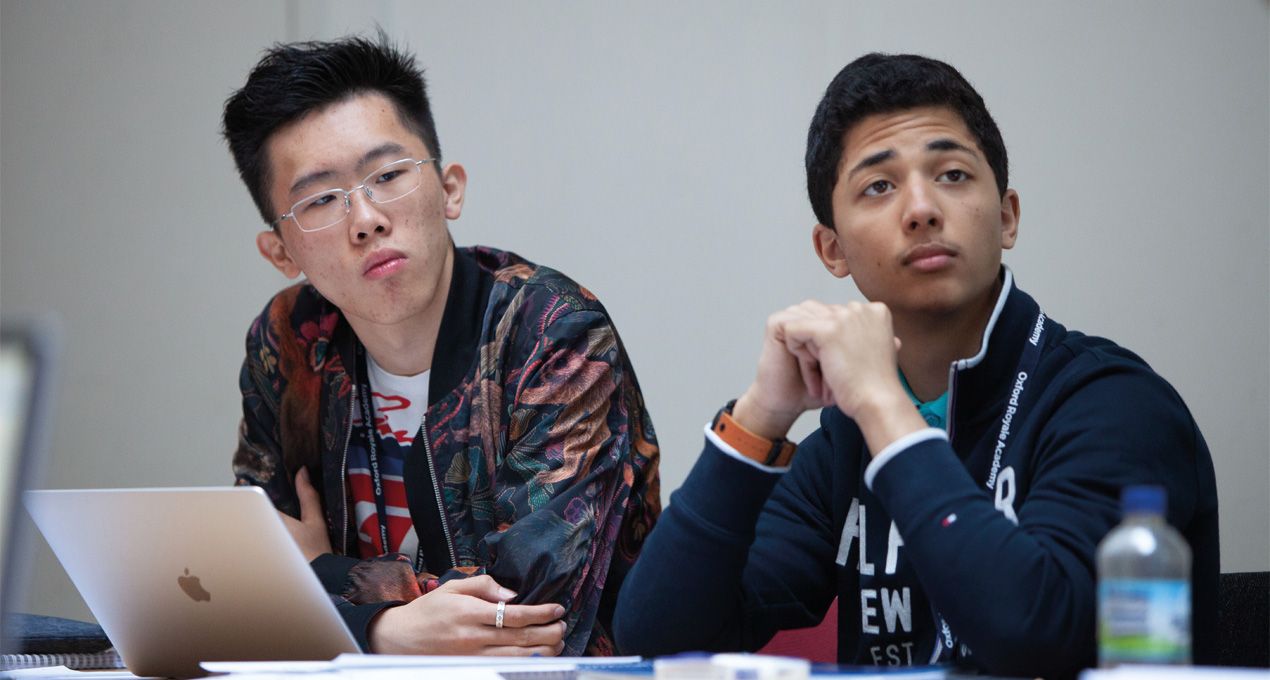 Two male students listening in class