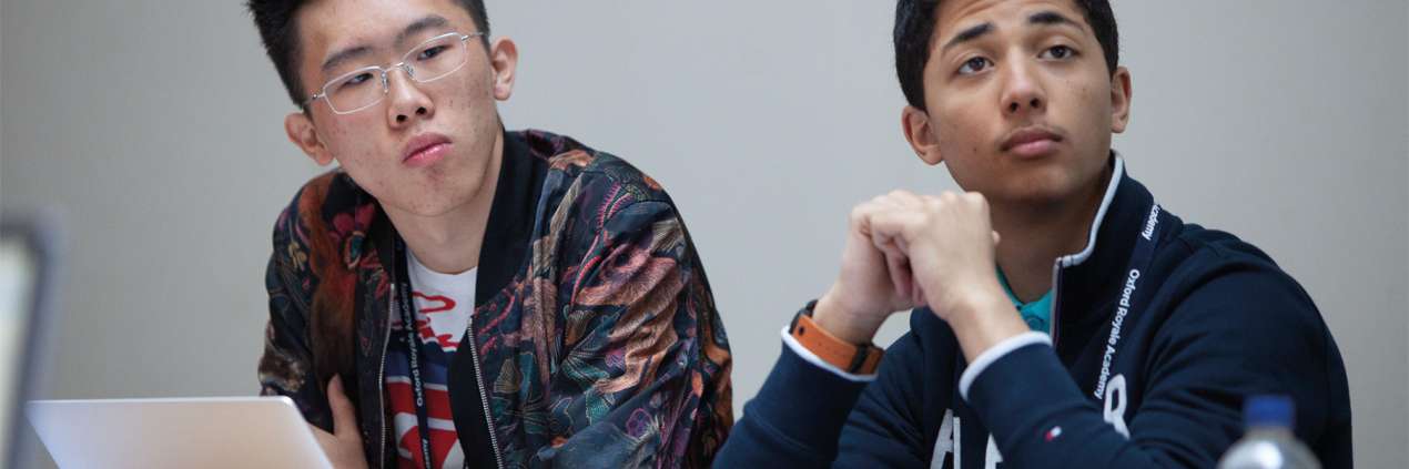 Two male students listening in class