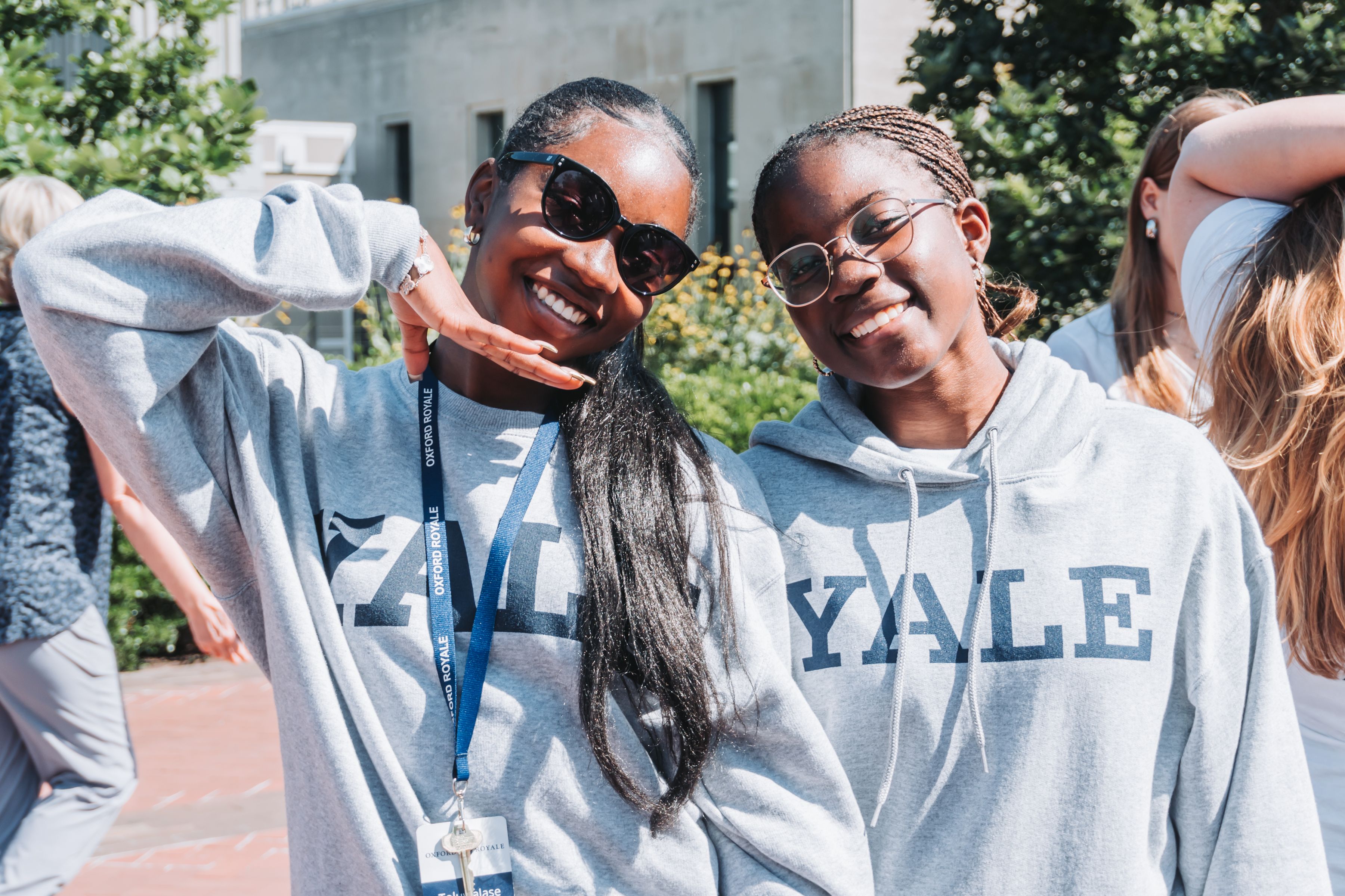 Two students smiling at the camera wearing Yale sweatshirts