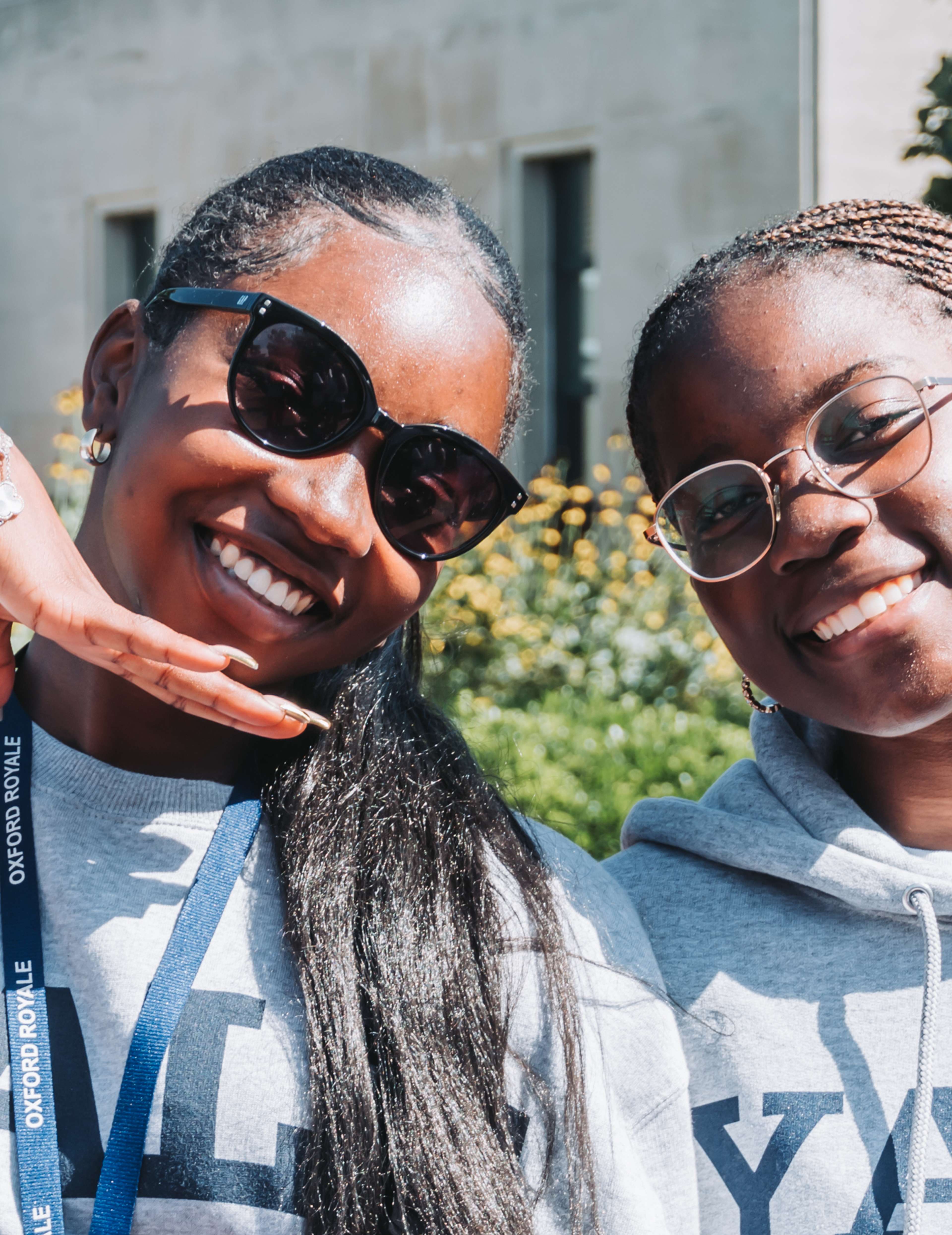 Two Oxford Royale students smile to camera wearing Yale hoodies