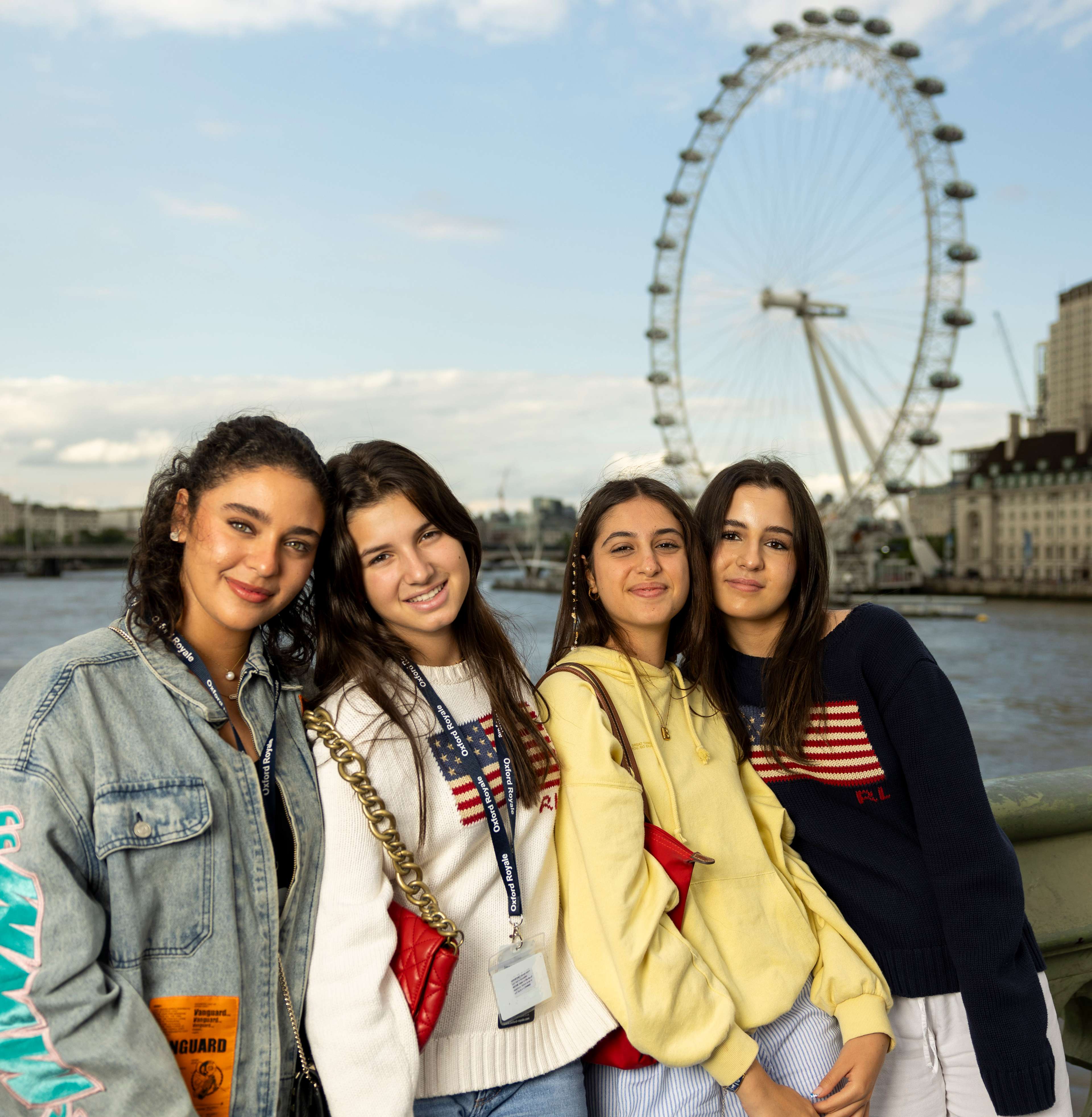 Group of students smiling in front of the London Eye