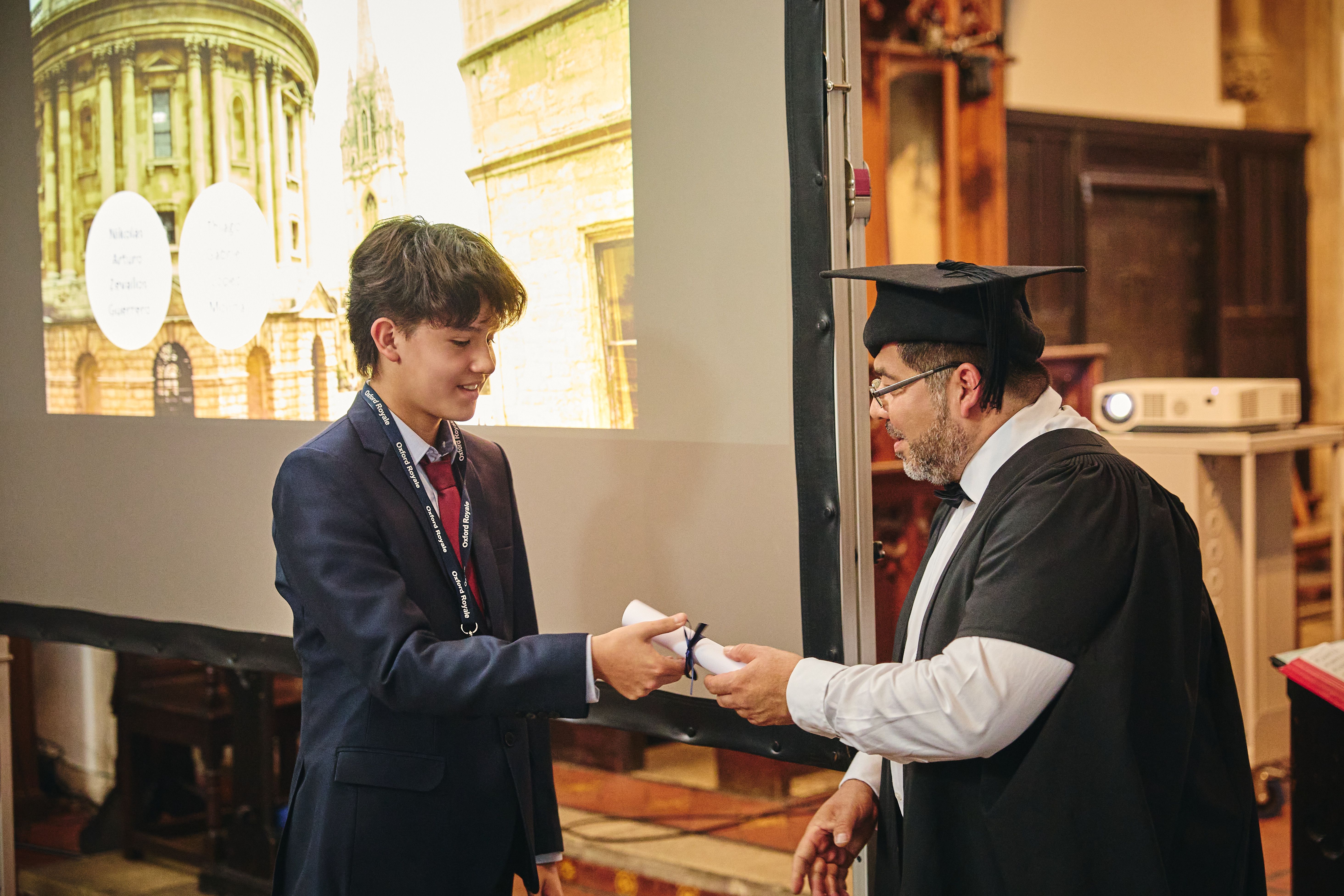 Student receiving their graduation scroll