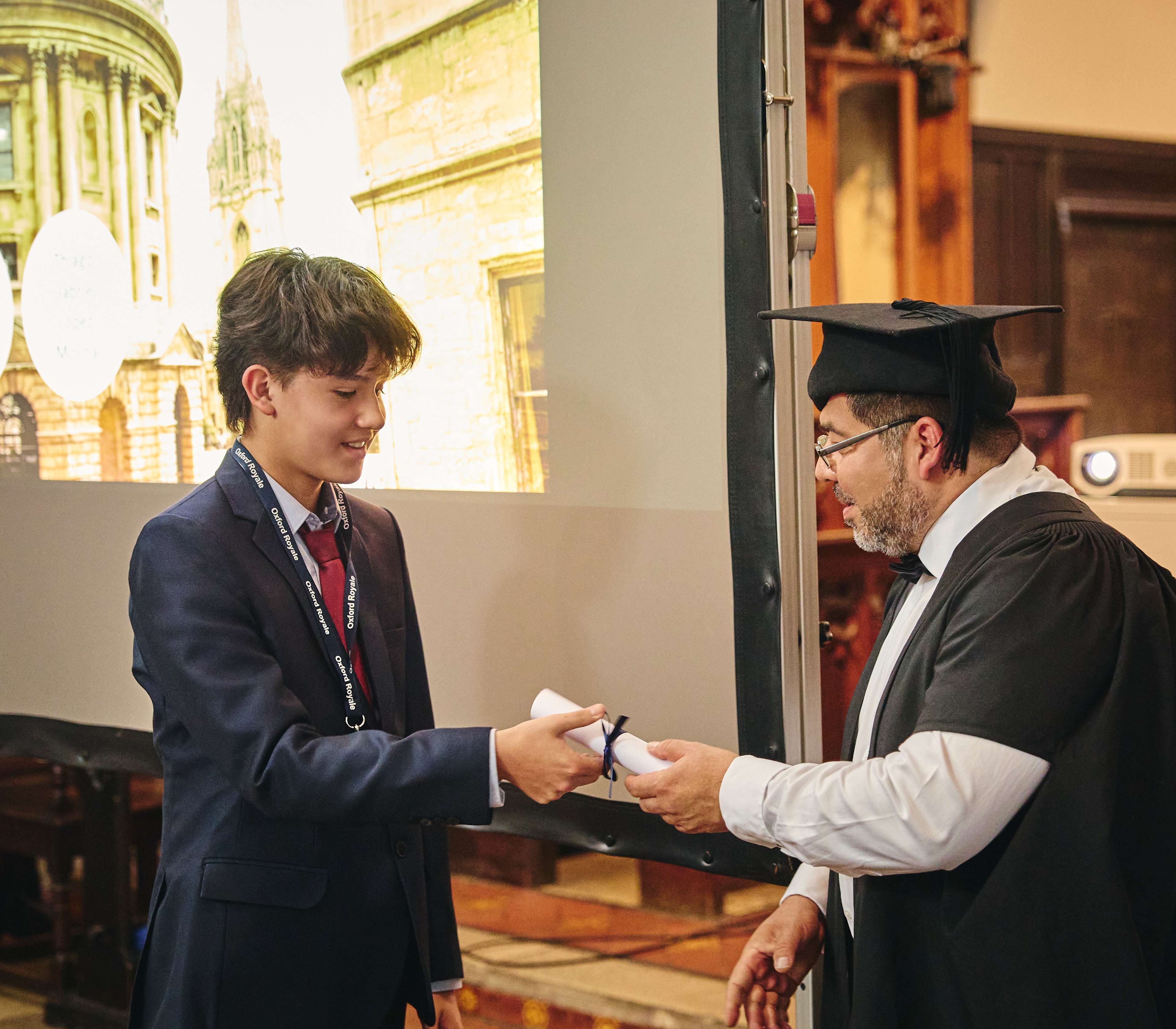 Student receiving their graduation scroll