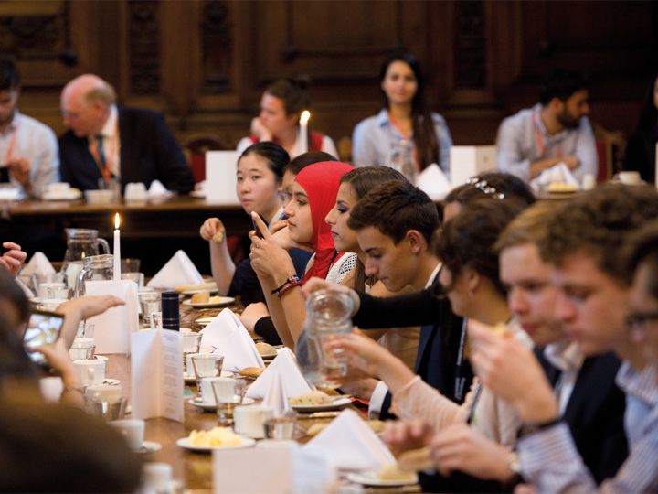 Oxford royale students in a Cambridge dining hall