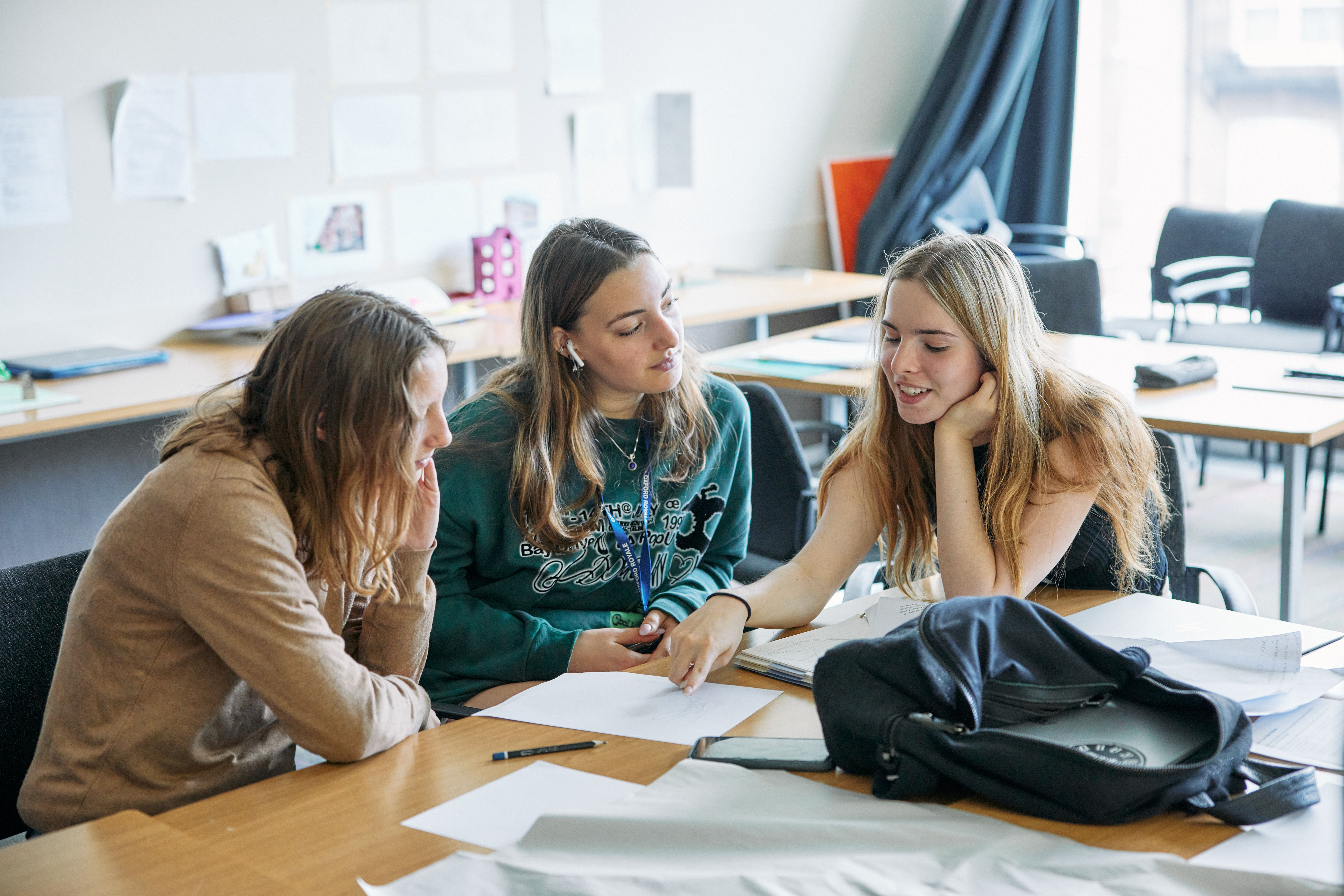 Three female students working on a project together