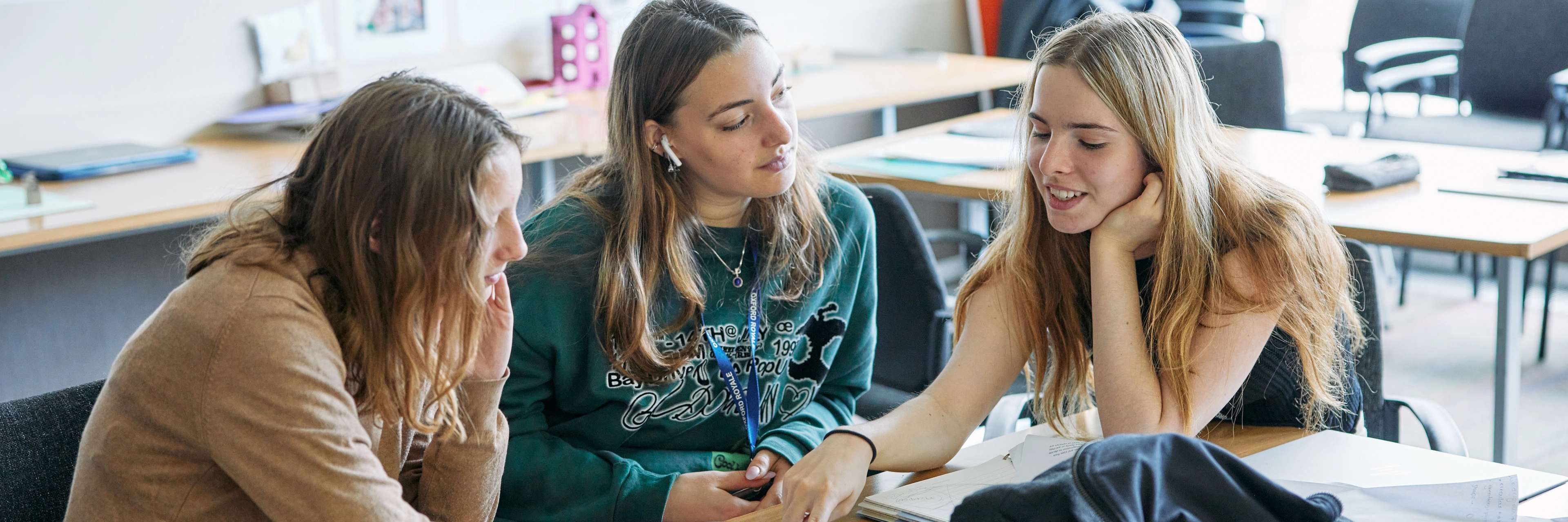 Three female students working on a project together