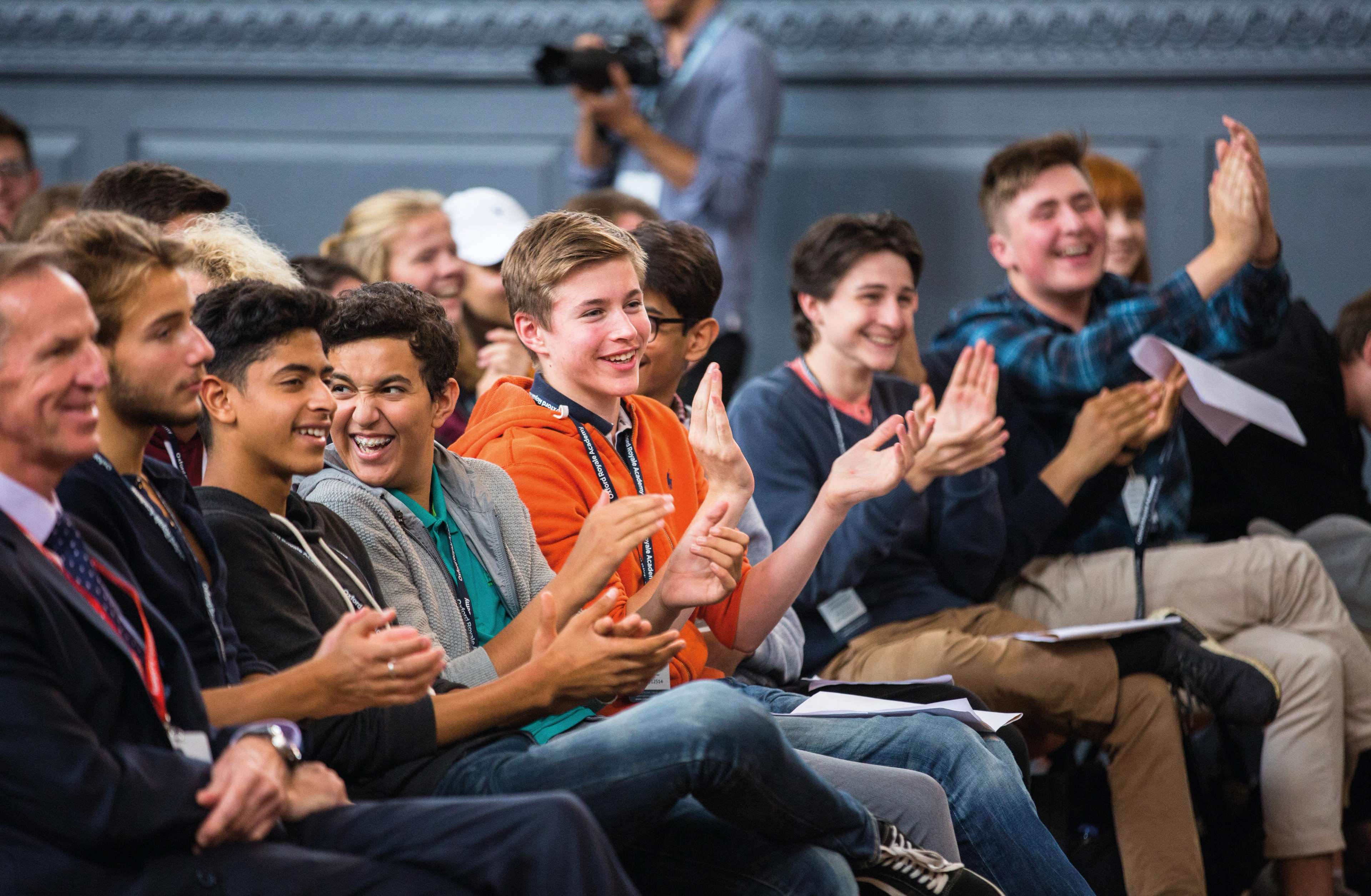Students clapping while listening to a speaker