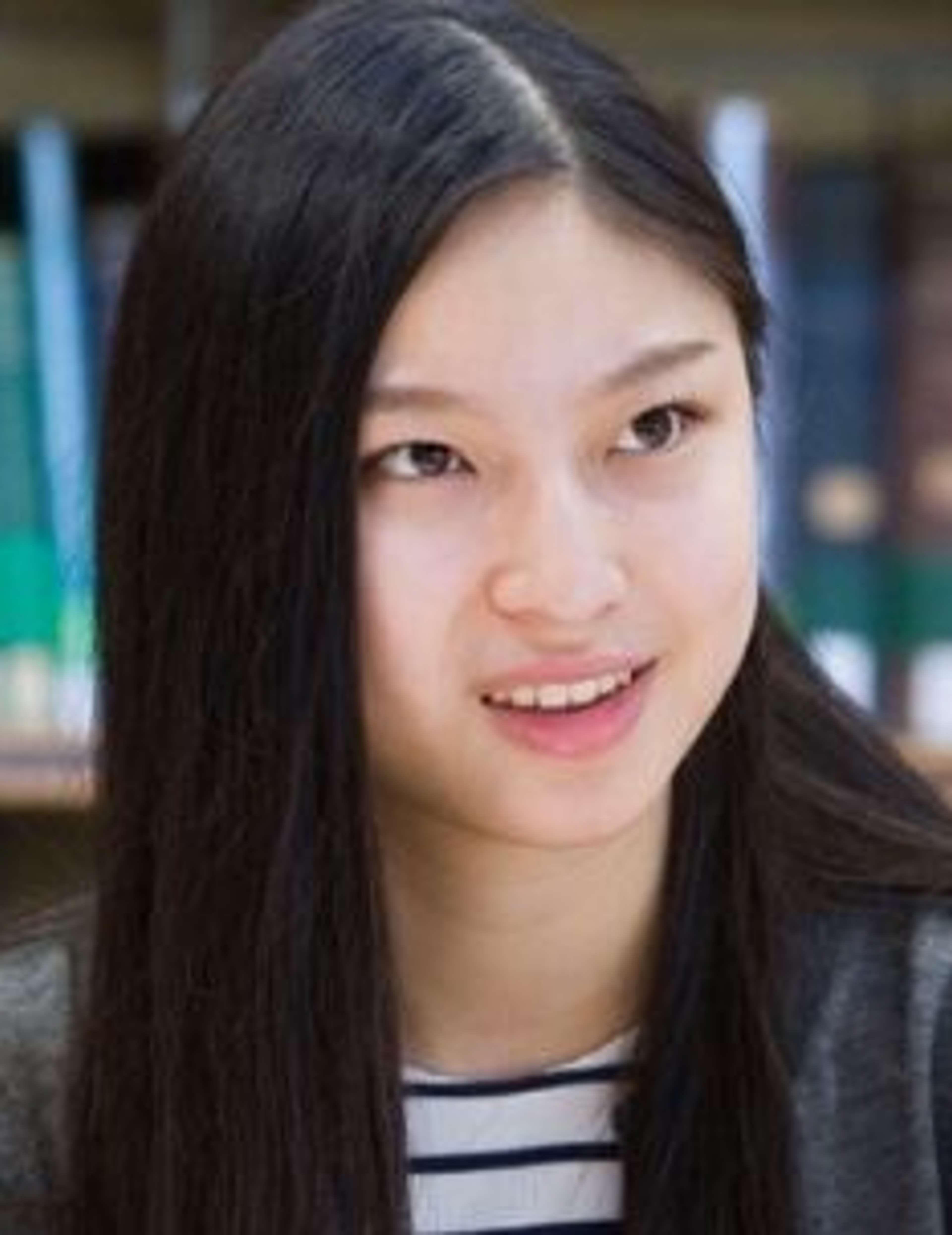 Oxford Royale Student listening with books in the background