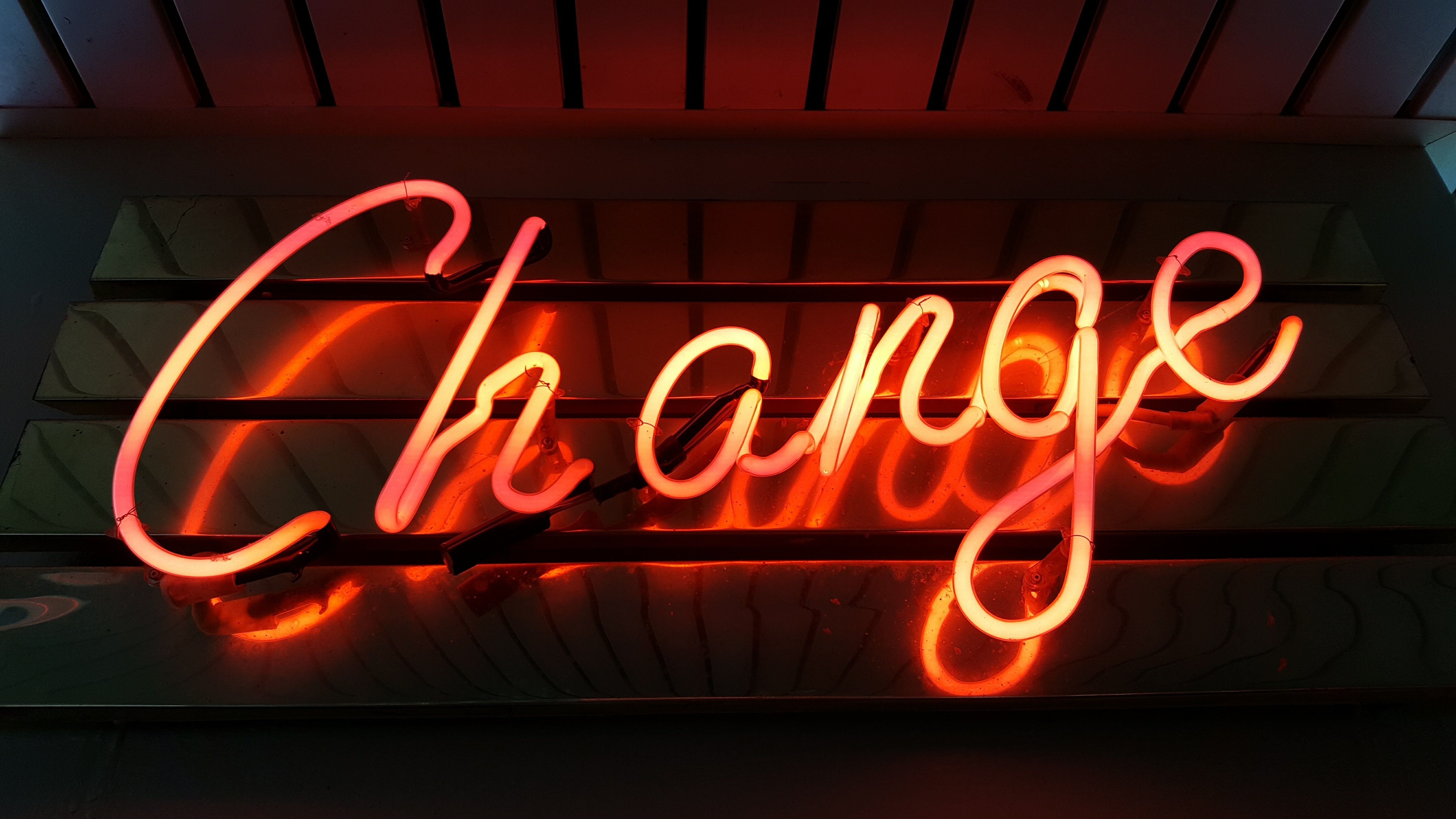 A neon sign that says change