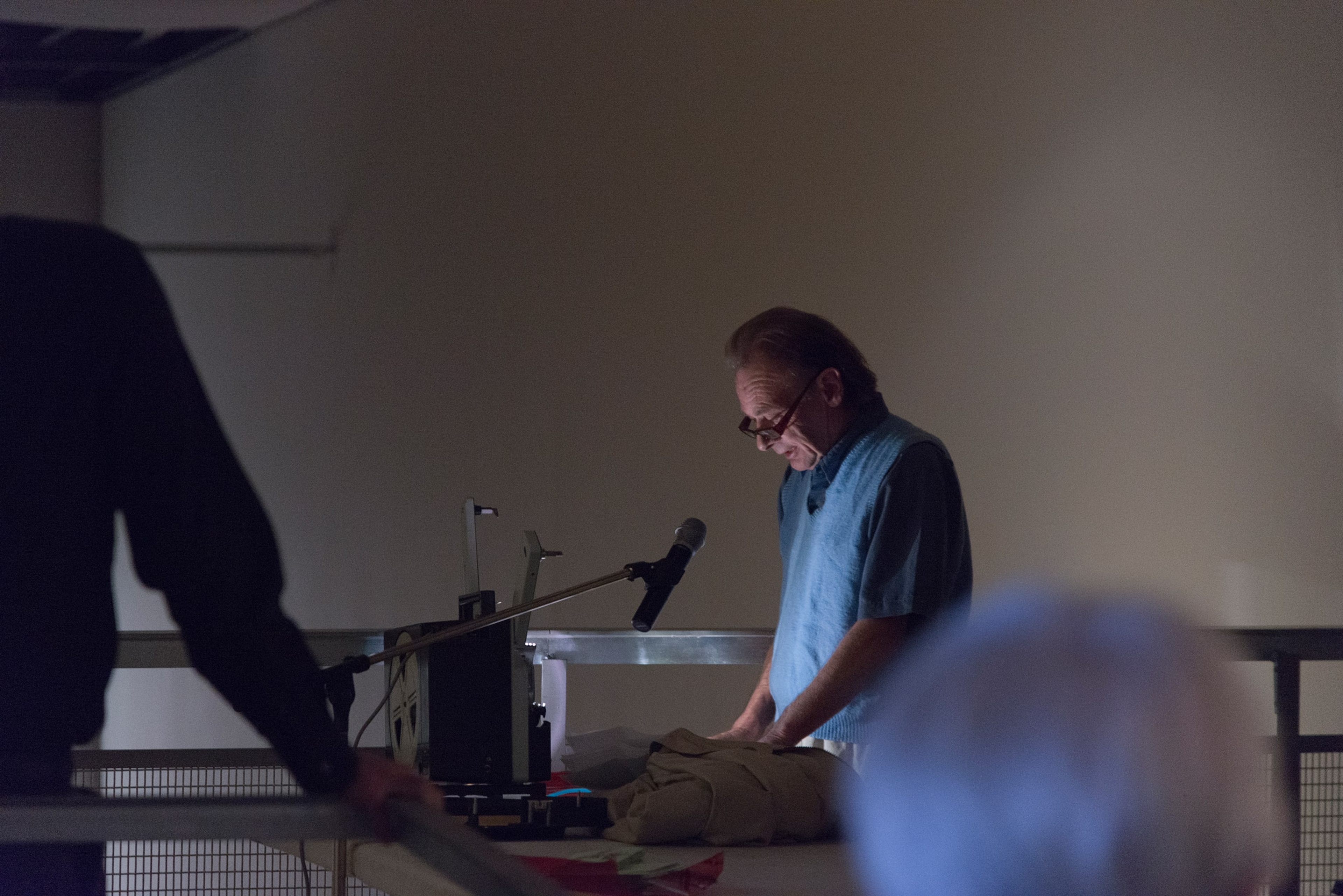 Hollis Frampton, A LECTURE, October 30, 1968, performed on February 11, 2014 by Martin Rumsby at the Adam Art Gallery. Script, 16mm projector, red filter, pipe cleaner. Courtesy of the Estate of Hollis Frampton. Photo: Shaun Waugh.