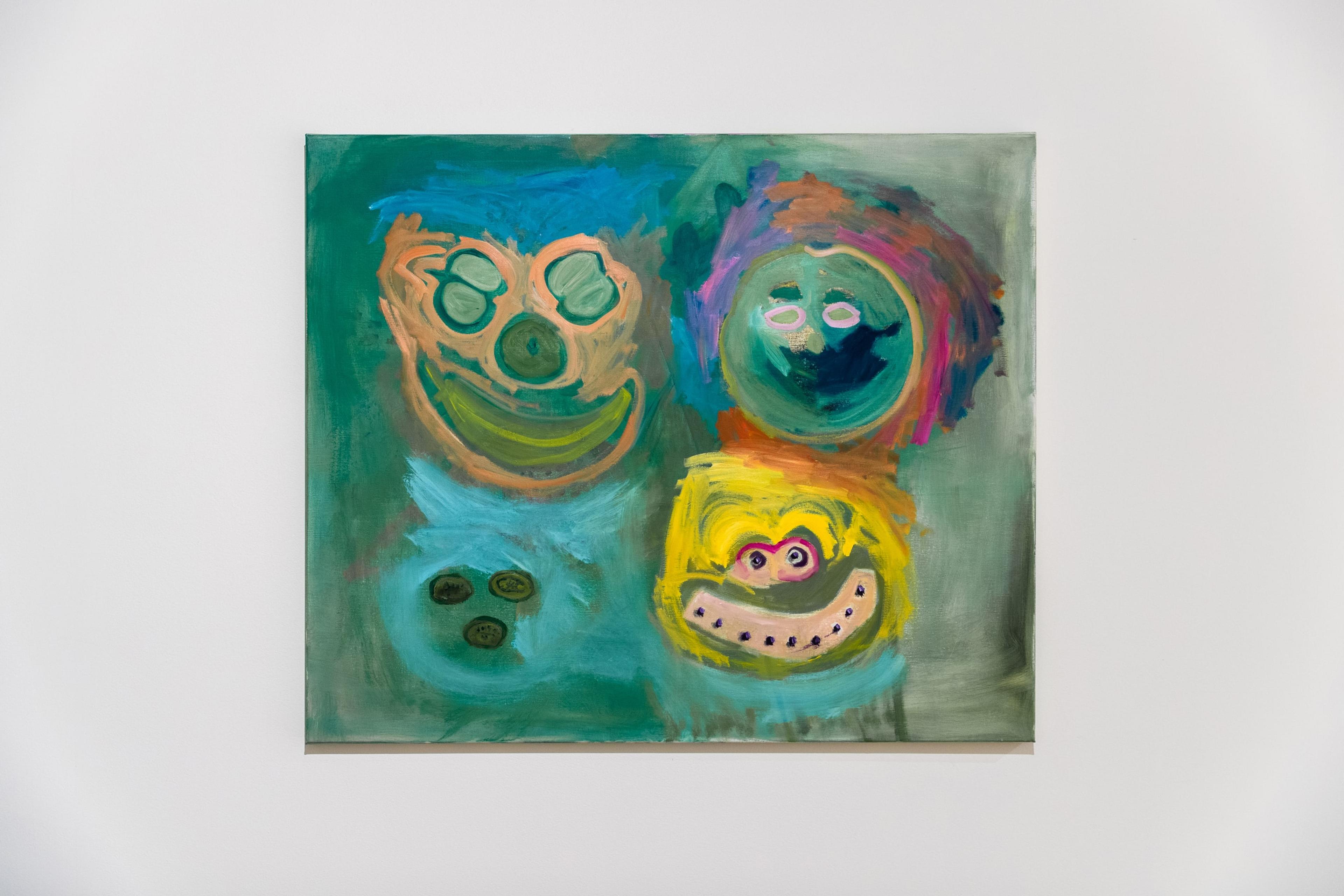 A painting of 4 colourful smudgy faces, mounted on a white wall