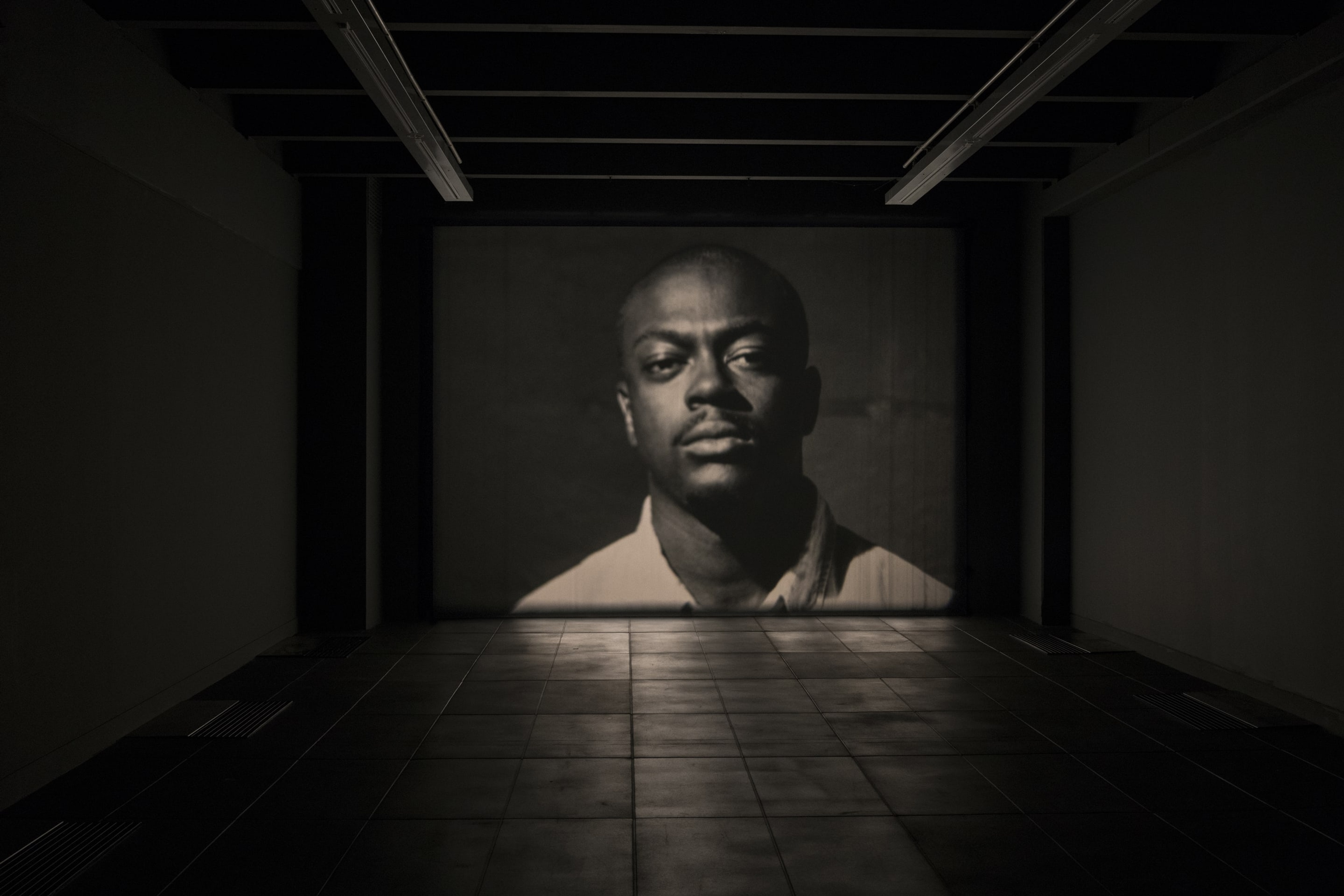 Luke Willis Thompson, Cemetery of Uniforms and Liveries, 2016, 16mm, b&w film, silent, 8 minutes, 50 seconds @ 24 fps. Installation view at Adam Art Gallery Te Pātaka Toi, Victoria University of Wellington, 21 February – 15 April 2018