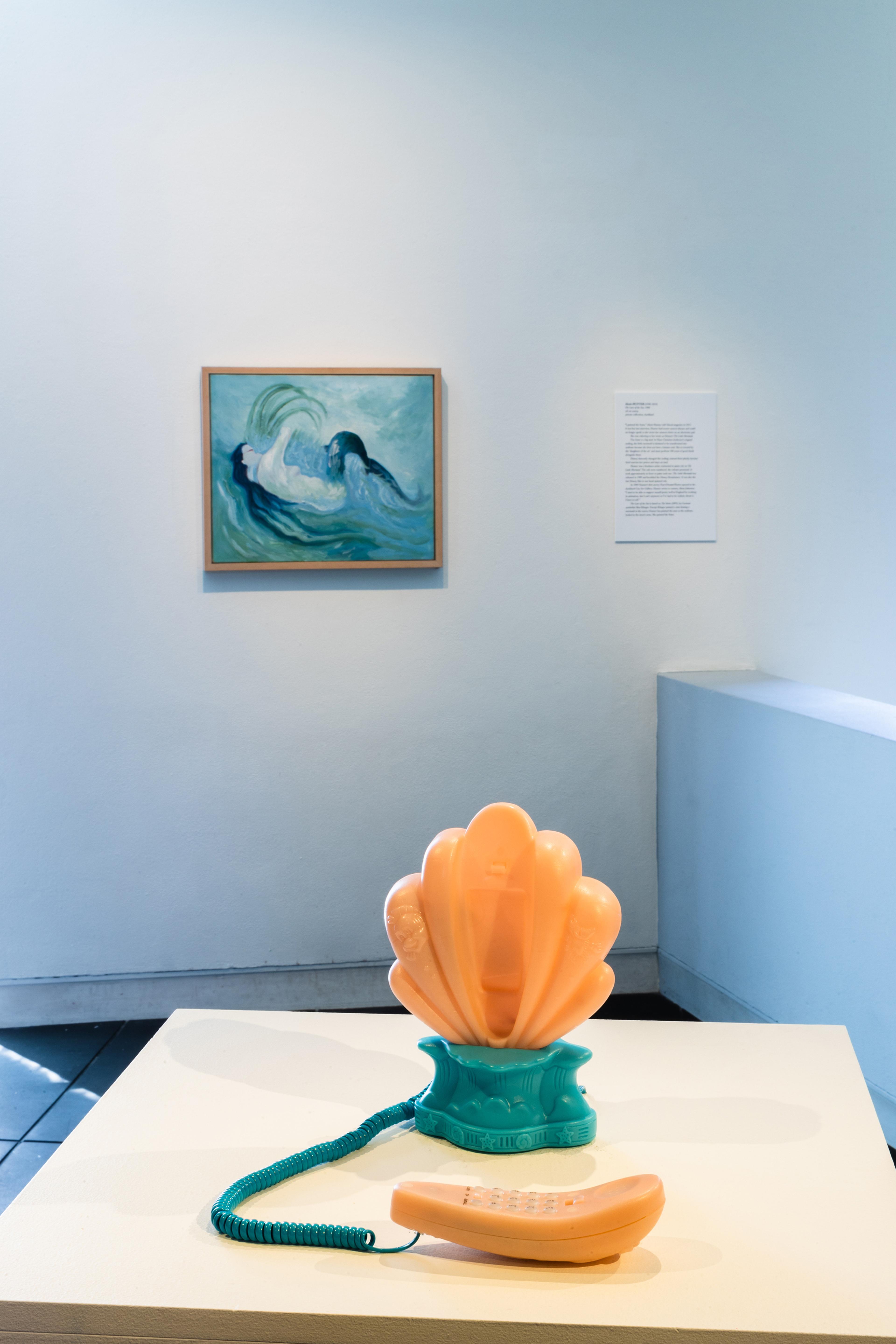 Alexis Hunter (1948–2014), The Lure of the Sea, 1988, oil on canvas, private collection, Auckland; Megan Dunn, I’ve Heard the Mermaids…, 2022, recorded sound, novelty telephone, collection of Megan Dunn. Installation view, Megan Dunn: The Mermaid Chronicles, Te Pātaka Toi Adam Art Gallery, Te Herenga Waka Victoria University of Wellington, 2022. Photo: Ted Whitaker