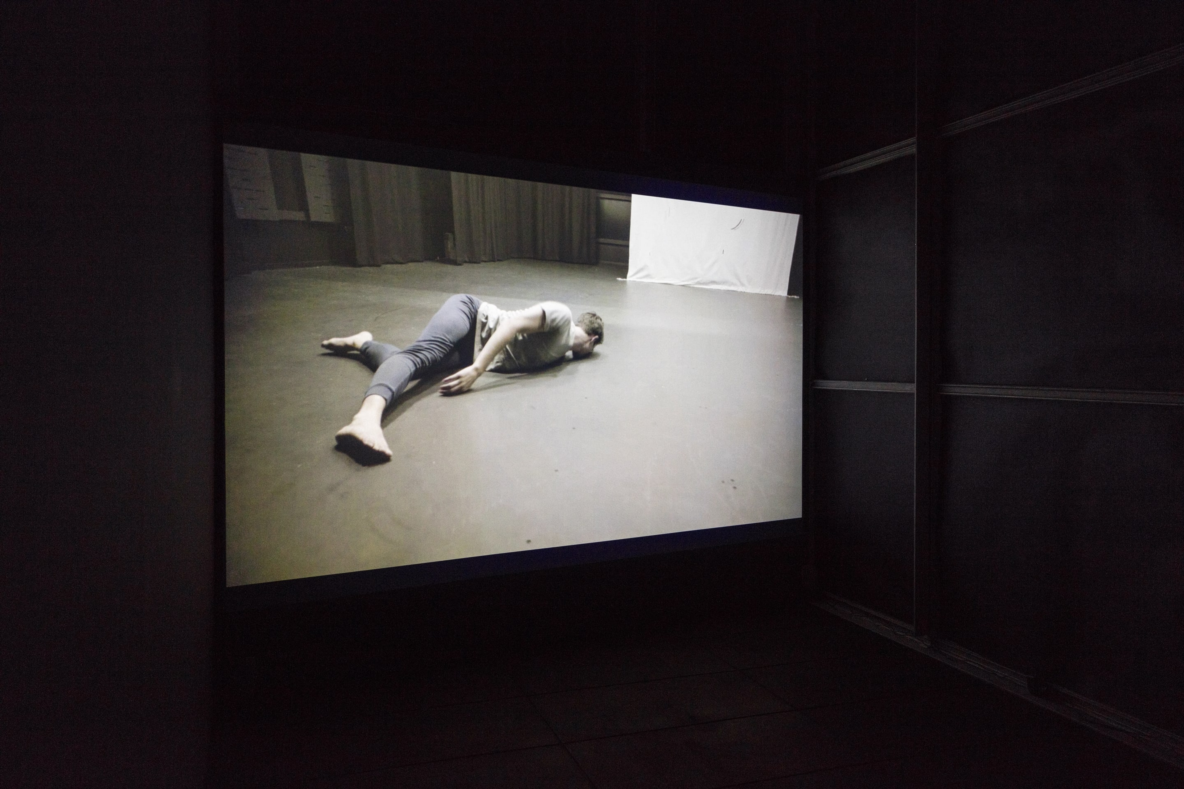 Installation view of Sriwhana Spong, The Fourth Notebook, 2015, HD video, 8 mins, 36 secs. Courtesy of Michael Lett, Auckland. Dancer: Benjamin Ord. Commissioned by Carriageworks, Sydney. In the exhibition Inhabiting Space at the Adam Art Gallery Te Pātaka Toi, Victoria University of Wellington (photo: Shaun Waugh)