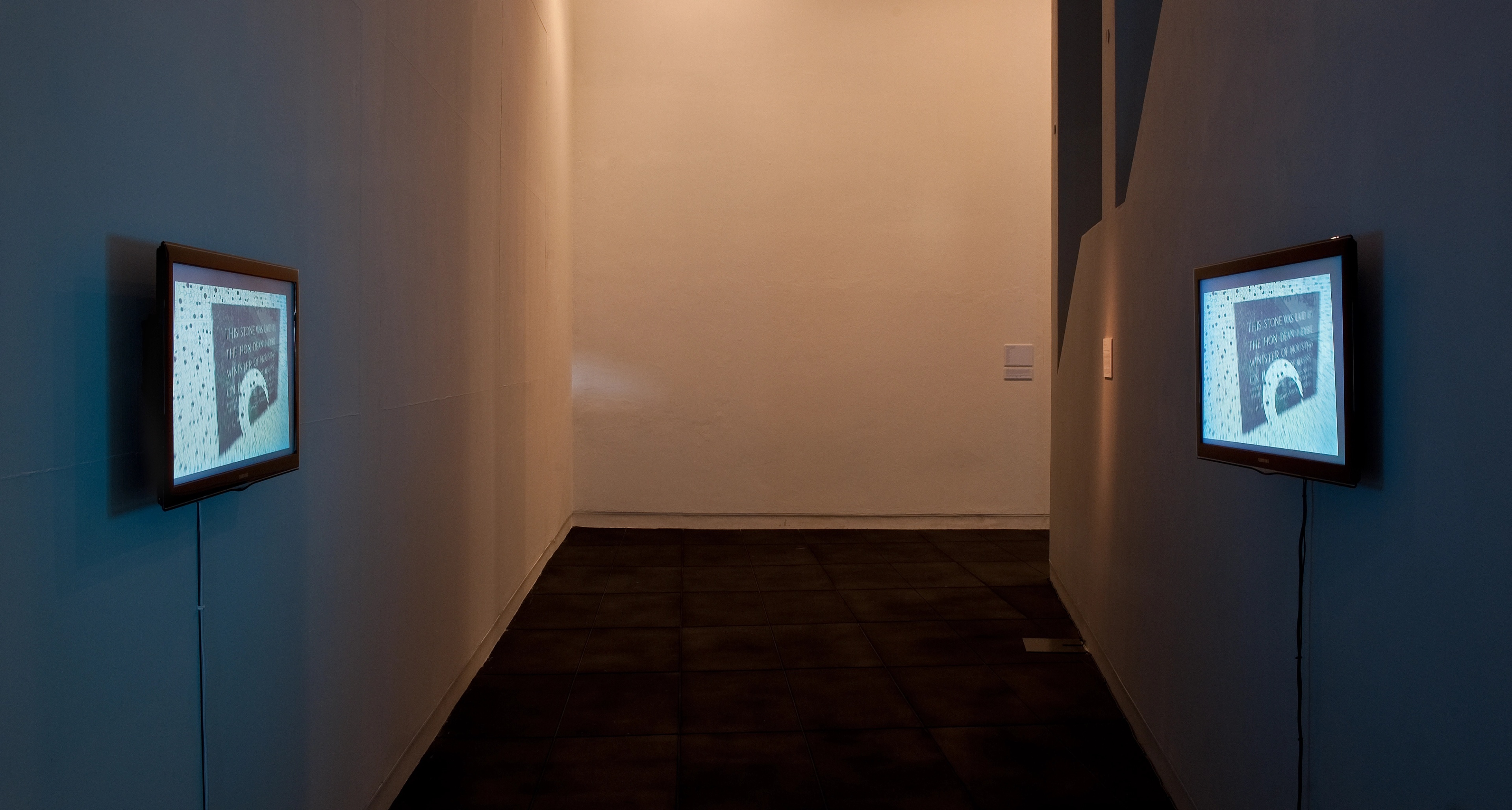 Installation view of Mladen Bizumic, From Cube to Ball: Photographed Slide-Show Filmed (2010). Double video projection, duration 5mins 9secs, looped. Victoria University of Wellington Art Collection, purchased 2011. Photo: Robert Cross